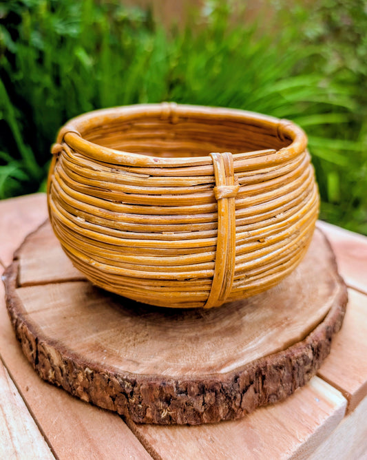 Bring warmth and natural texture to your home with this handwoven vintage rattan cachepot. Perfect for displaying a small plant, organizing everyday essentials, or adding an organic touch to a shelf or tabletop, this timeless basket complements coastal, cottage, and Pacific Northwest-inspired interiors.