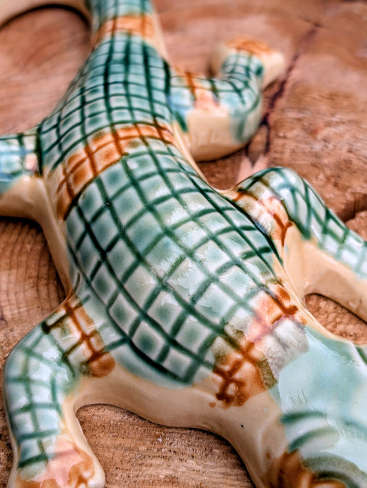 Bring a touch of whimsical European charm to your home or garden with this vintage ceramic alligator wall pocket. Featuring hand-painted green scales and a functional rear pocket for dried flowers or an air plant, it's a delightful accent for cottage-inspired interiors and nature lovers alike.