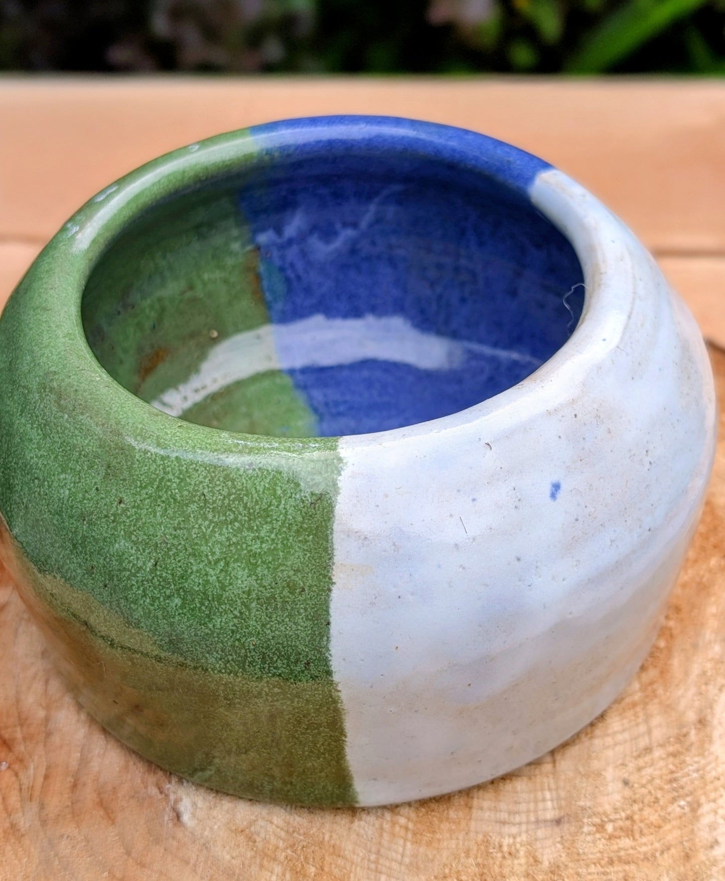 A beautifully hand-thrown studio pottery succulent planter featuring layered blue, moss green, and soft white glazes over high-fired stoneware. Complete with an integrated drainage hole and signed by the artist with the monogram "G.M.," this artisan planter brings handcrafted character to any home or garden.