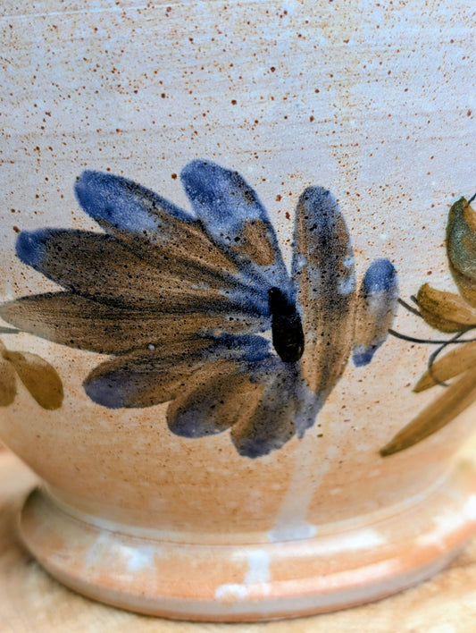 Bring warmth and handcrafted character to your home with this vintage hand-thrown terracotta footed bowl. Featuring a hand-painted floral motif and rich earthy tones, it serves beautifully as both functional serveware and timeless decorative pottery.