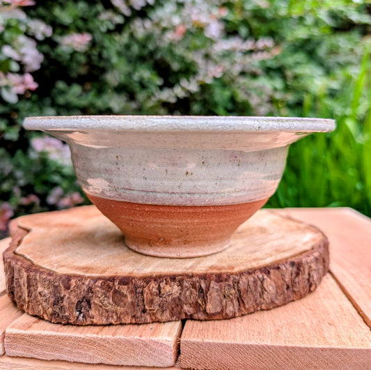 Handcrafted with timeless simplicity, this signed studio pottery serving bowl pairs a soft celadon-gray glaze with a warm iron-rich stoneware body. Its versatile size and understated design make it equally beautiful for serving, display, or everyday living.