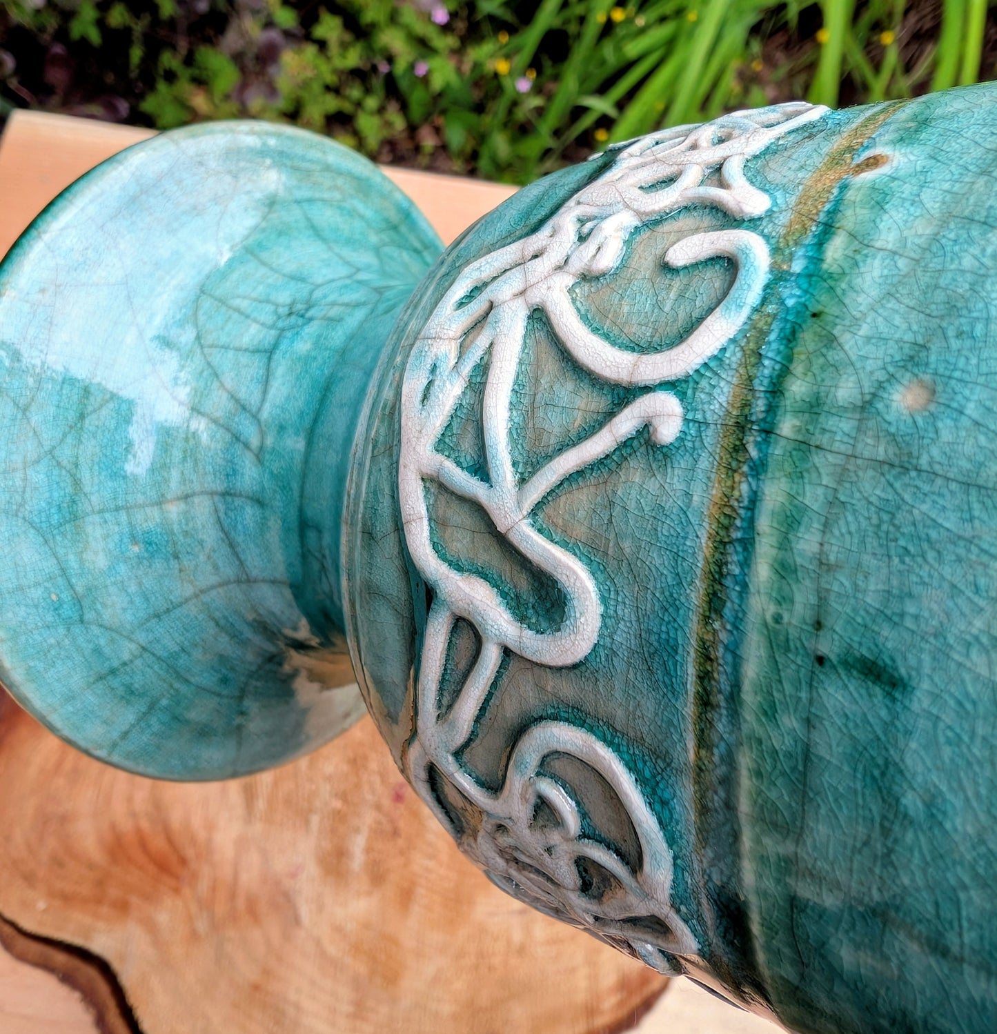 Celebrate the artistry of 1970s studio ceramics with this signed and dated handmade stoneware vase. Finished in a rich teal crackle glaze with distinctive white applied slip decoration, this sculptural piece brings timeless character to shelves, tables, and curated collections.