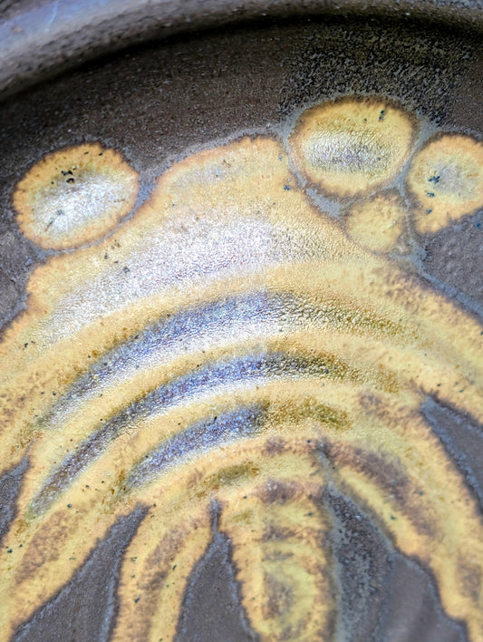Celebrate the beauty of handmade craftsmanship with this one-of-a-kind studio pottery art plate featuring an expressive abstract octopus-inspired design. Rich earth-tone glazes and visible throwing rings make this versatile stoneware piece equally at home as functional serveware or coastal-inspired wall décor.