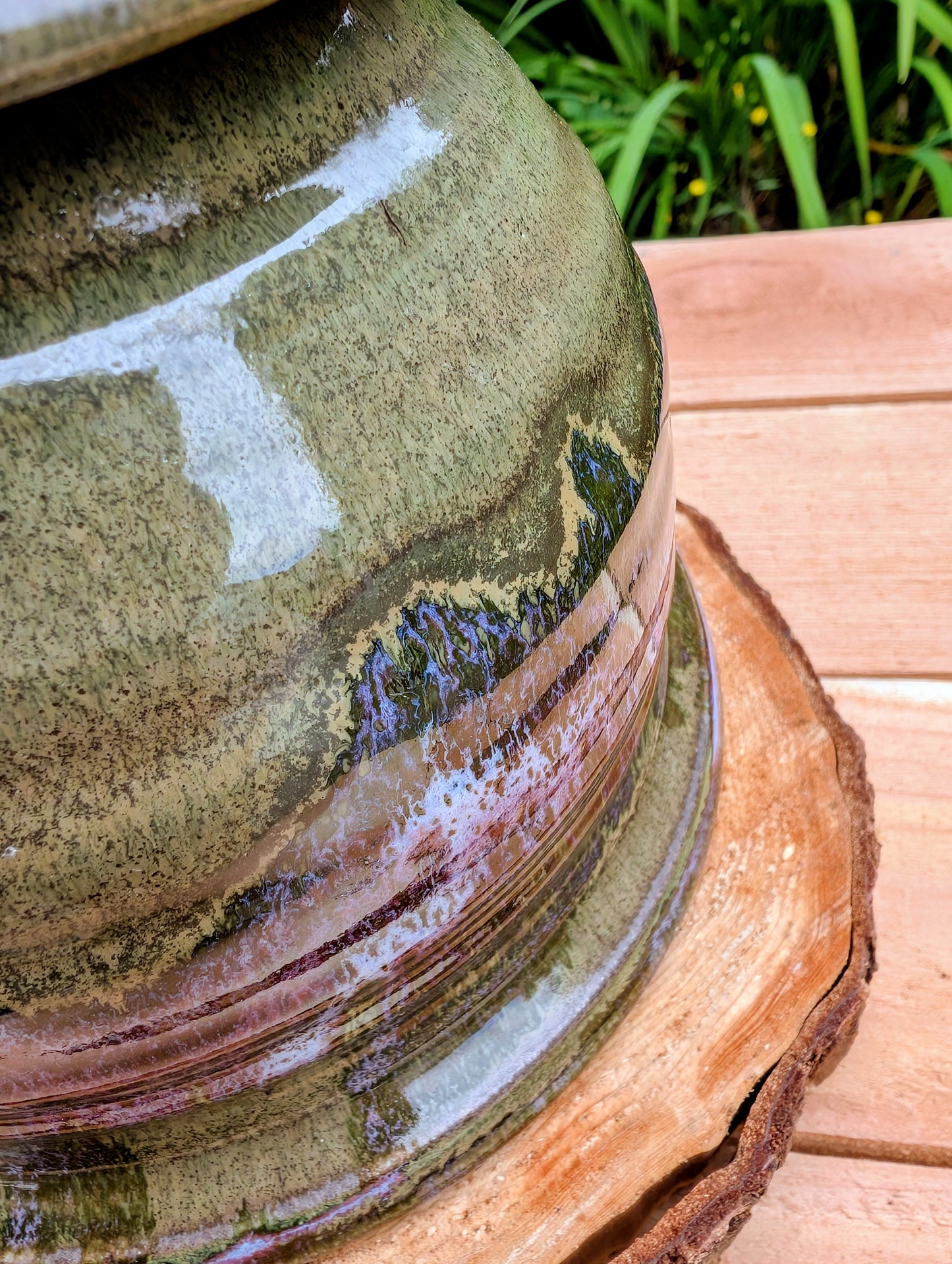 Handcrafted in Snohomish, Washington, this authentic Bruning Pottery stoneware planter showcases flowing moss green, olive, brown, and plum glazes inspired by the Pacific Northwest landscape. Complete with an integrated saucer, it's a beautiful and functional piece for houseplants, herbs, or succulent collections.