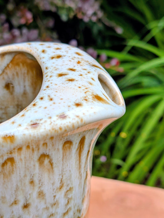 Bring timeless American craftsmanship into your home with this vintage Canonsburg Pottery Carefree Ironstone pitcher in the sought-after Butterscotch pattern. Its warm caramel glaze and signature white drip finish make it equally beautiful as a serving pitcher, floral vase, or rustic farmhouse accent.