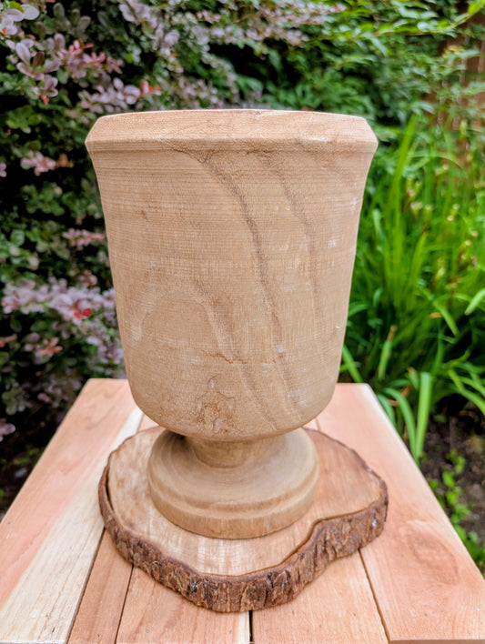 Bring natural warmth and organic texture into your home with this hand-carved paulownia wood footed vase. Its sculptural silhouette and unfinished wood grain make it a timeless accent for dried botanicals, seasonal branches, or as a beautiful standalone decorative piece.