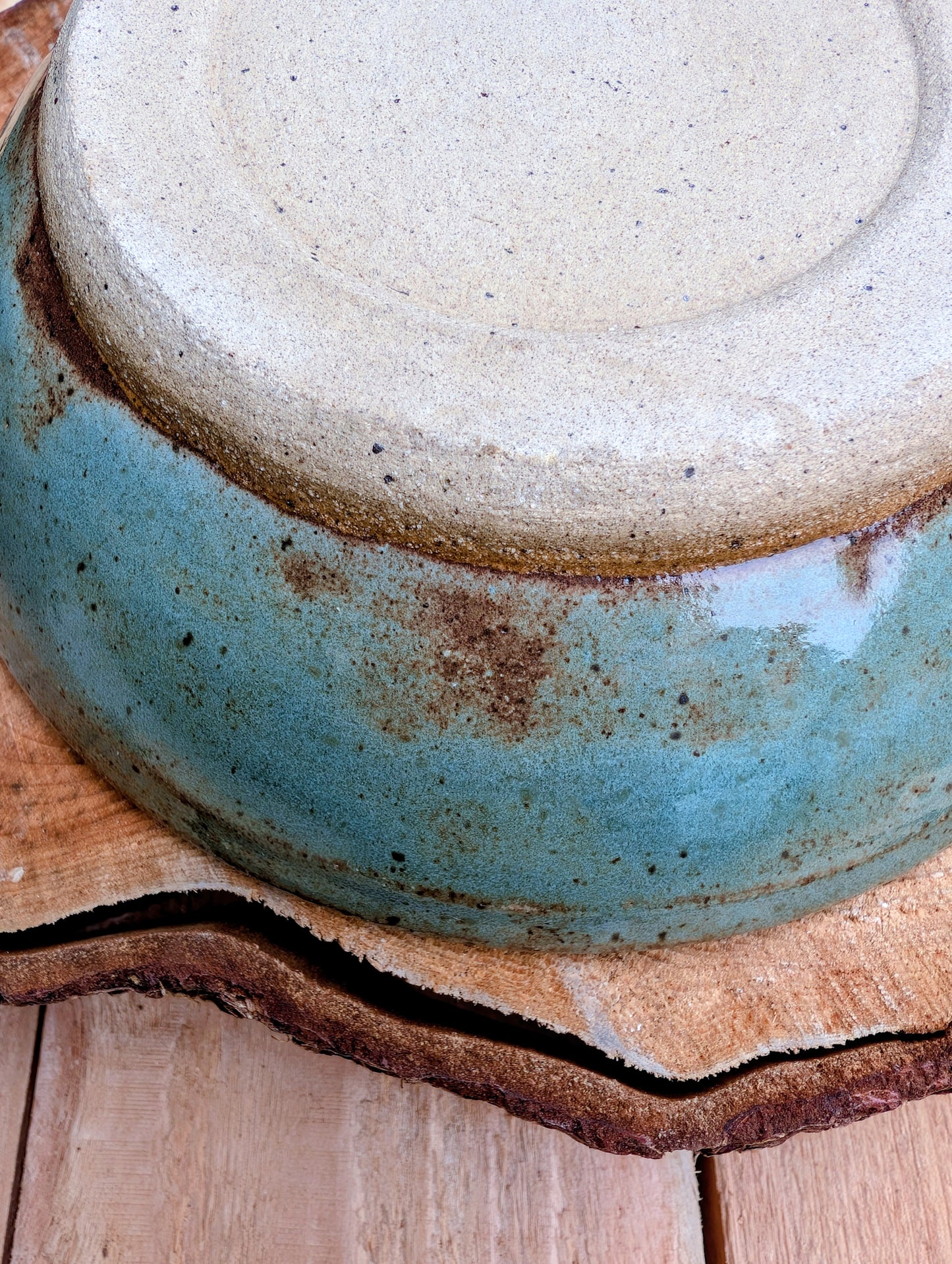 Bring the calming colors of the Pacific Northwest into your home with this handcrafted studio pottery bowl. Featuring layered blue, aqua, cream, and olive reactive glazes, this artisan stoneware piece is equally beautiful as a serving bowl or decorative display.