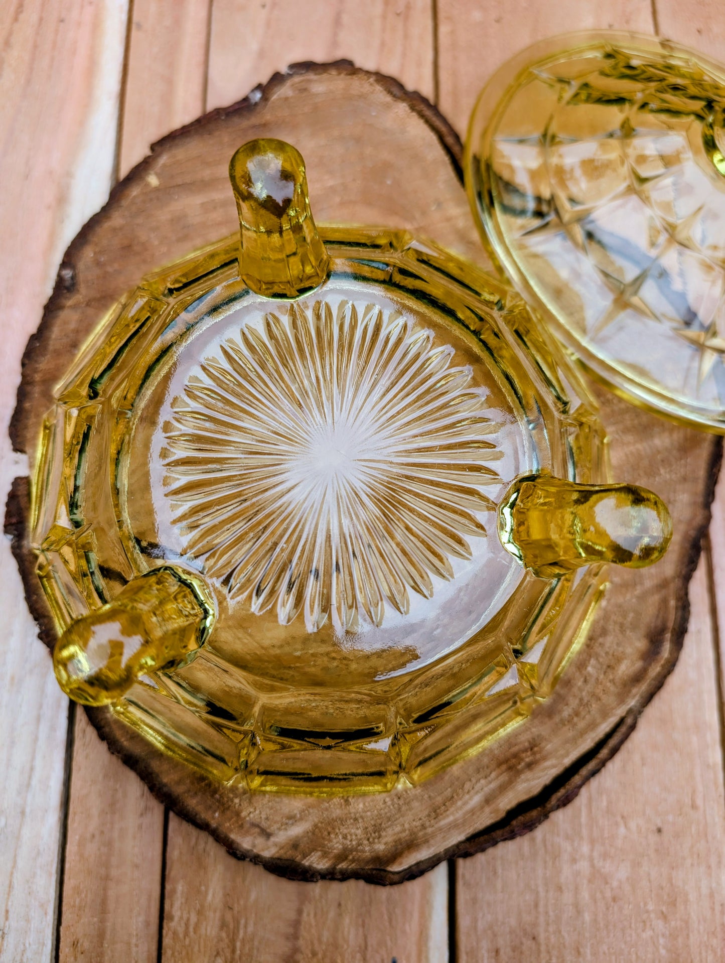 Bring warm vintage charm to your home with this beautiful Tiara Exclusives Constellation covered candy dish in the sought-after Yellow Mist color. Produced by Indiana Glass during the 1970s, its geometric star pattern and golden glow make it a timeless piece for entertaining or display.