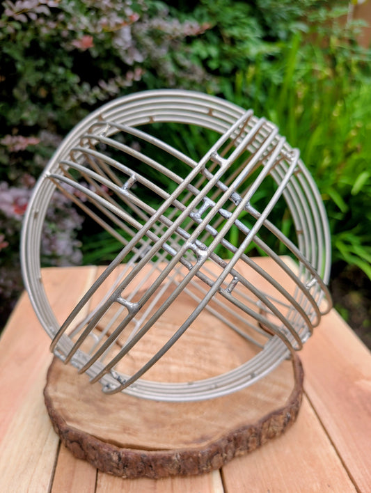 Bring sculptural simplicity to your home or garden with this stainless steel wire sphere. Its clean geometric design adds year-round visual interest, whether displayed on a tabletop, nestled among plants, or styled as a modern garden accent.