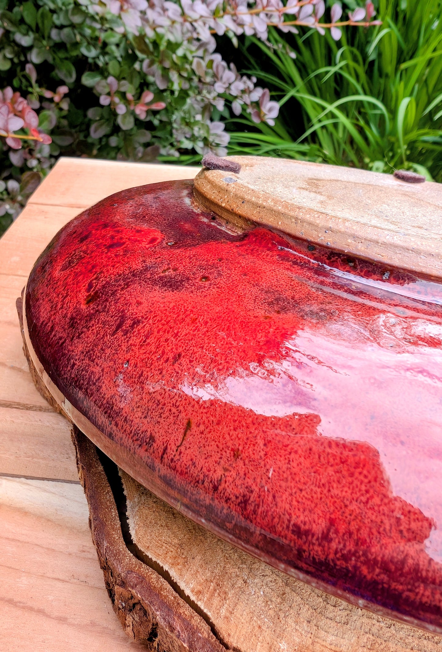 A beautifully hand-thrown studio pottery serving bowl signed and dated 1991, featuring a richly layered cobalt blue interior and deep oxblood exterior glaze. Whether used for serving or displayed as functional art, this handcrafted stoneware piece showcases the timeless beauty of American studio ceramics.