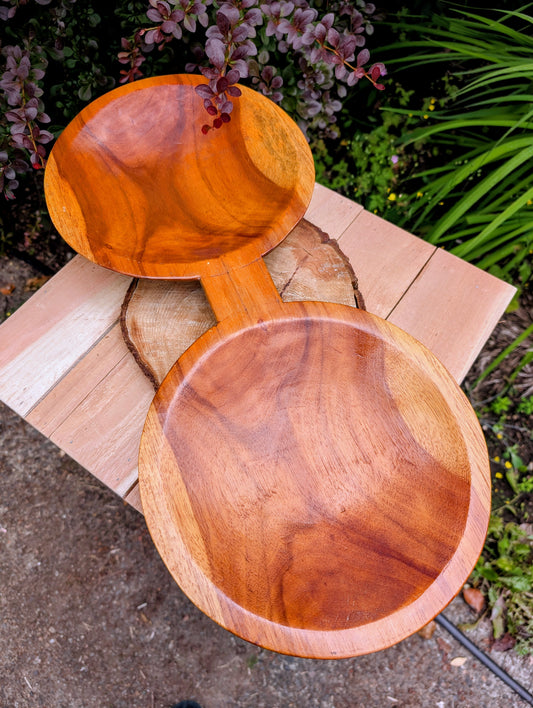 Serve with timeless style using this hand-carved Monkey Pod wood double serving tray. Crafted from a single piece of richly grained hardwood, its sculptural silhouette makes it equally beautiful as a serving piece or decorative centerpiece.