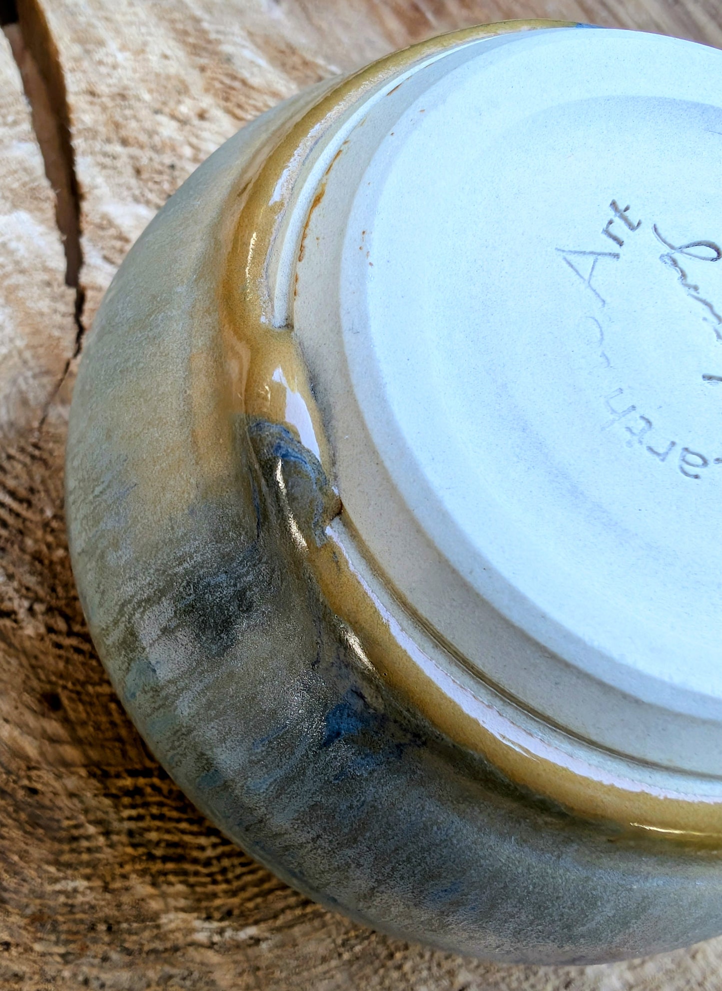 Ceramic bowl with gold rim on a wooden surface