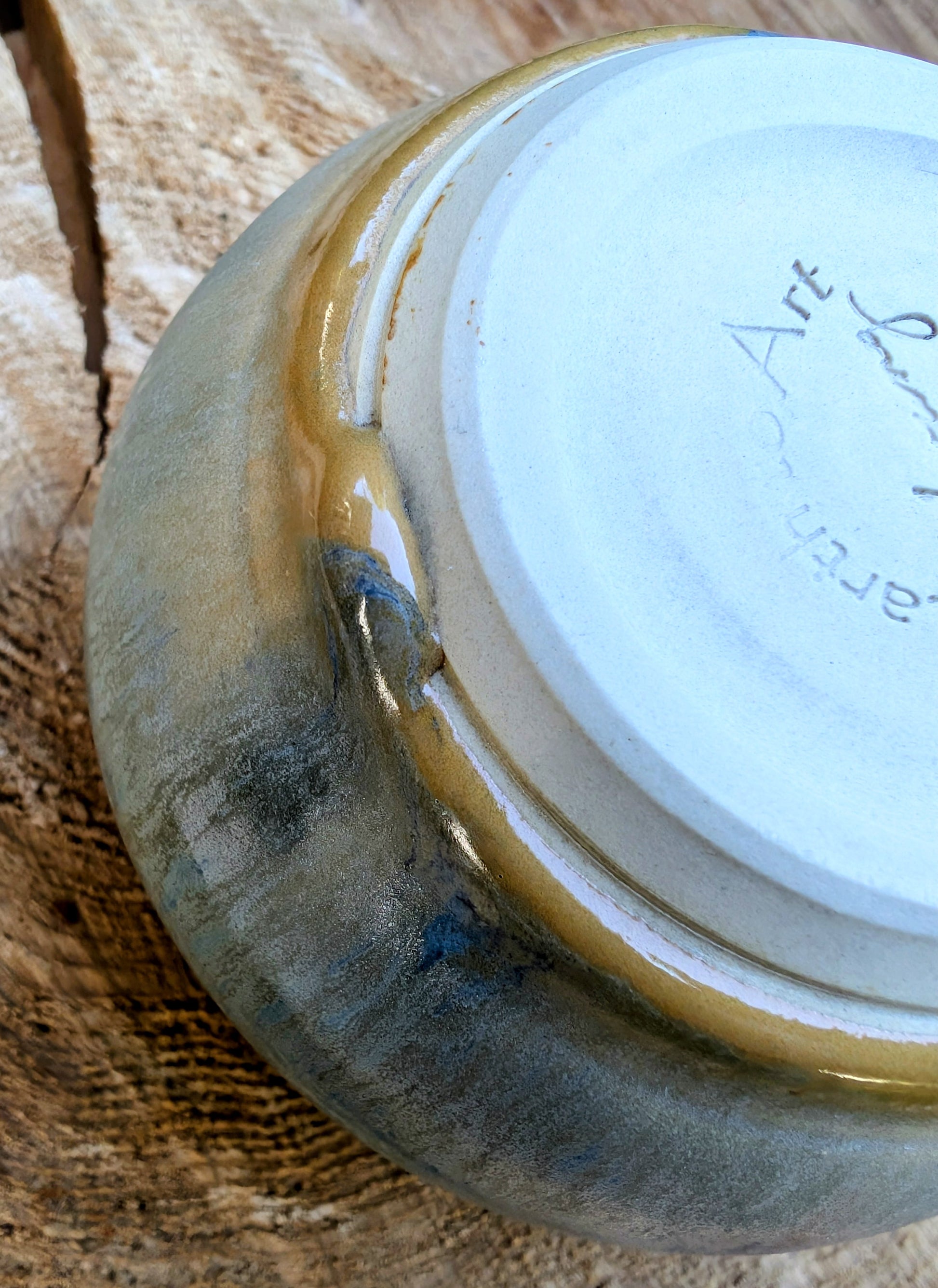 Ceramic bowl with gold rim on a wooden surface