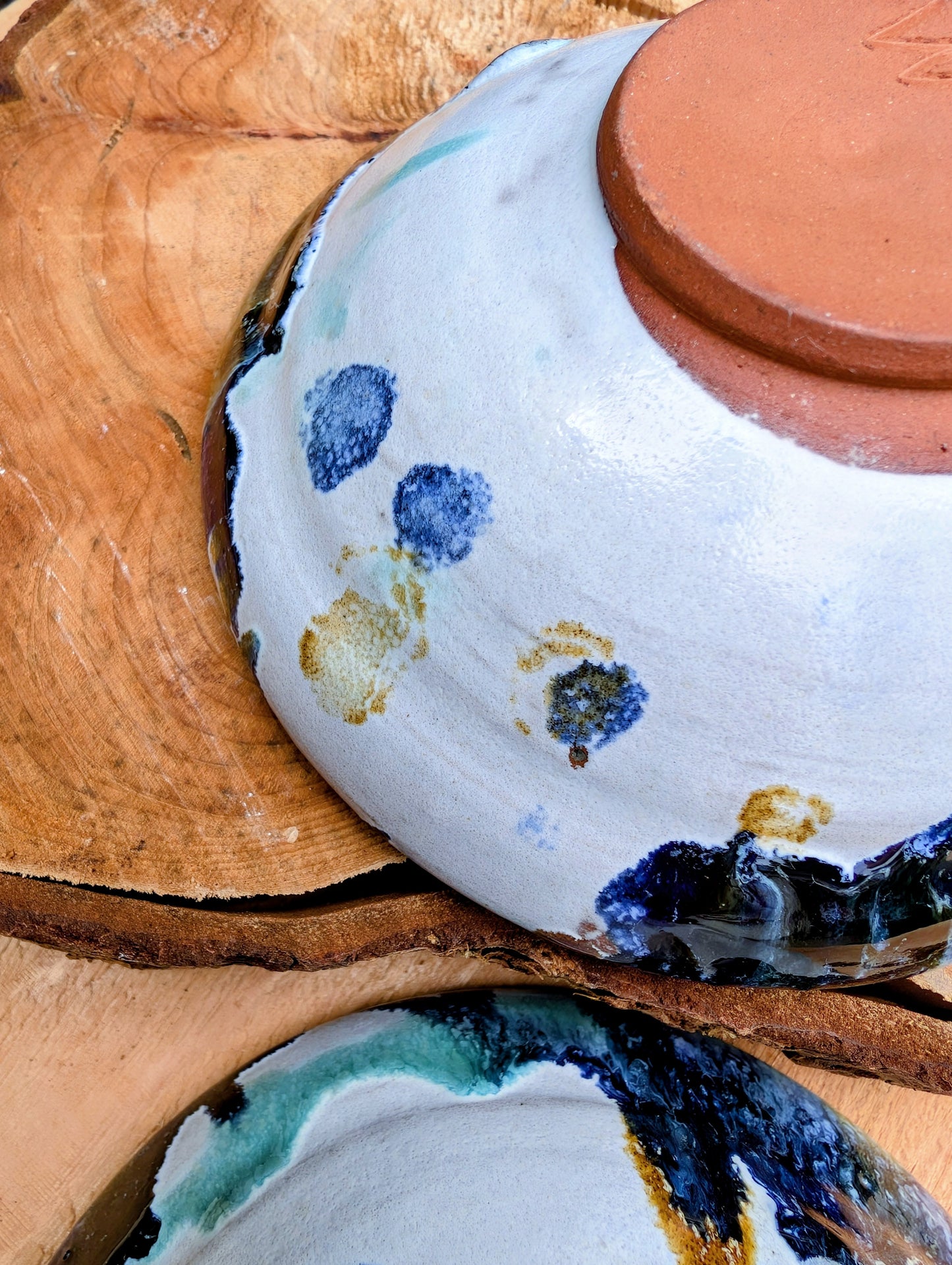 Bring handcrafted artistry to your table with this matching pair of signed studio pottery bowls. Finished with richly layered reactive glazes in cobalt blue, teal, amber, and ivory, these versatile artisan bowls are equally beautiful for entertaining or everyday display.