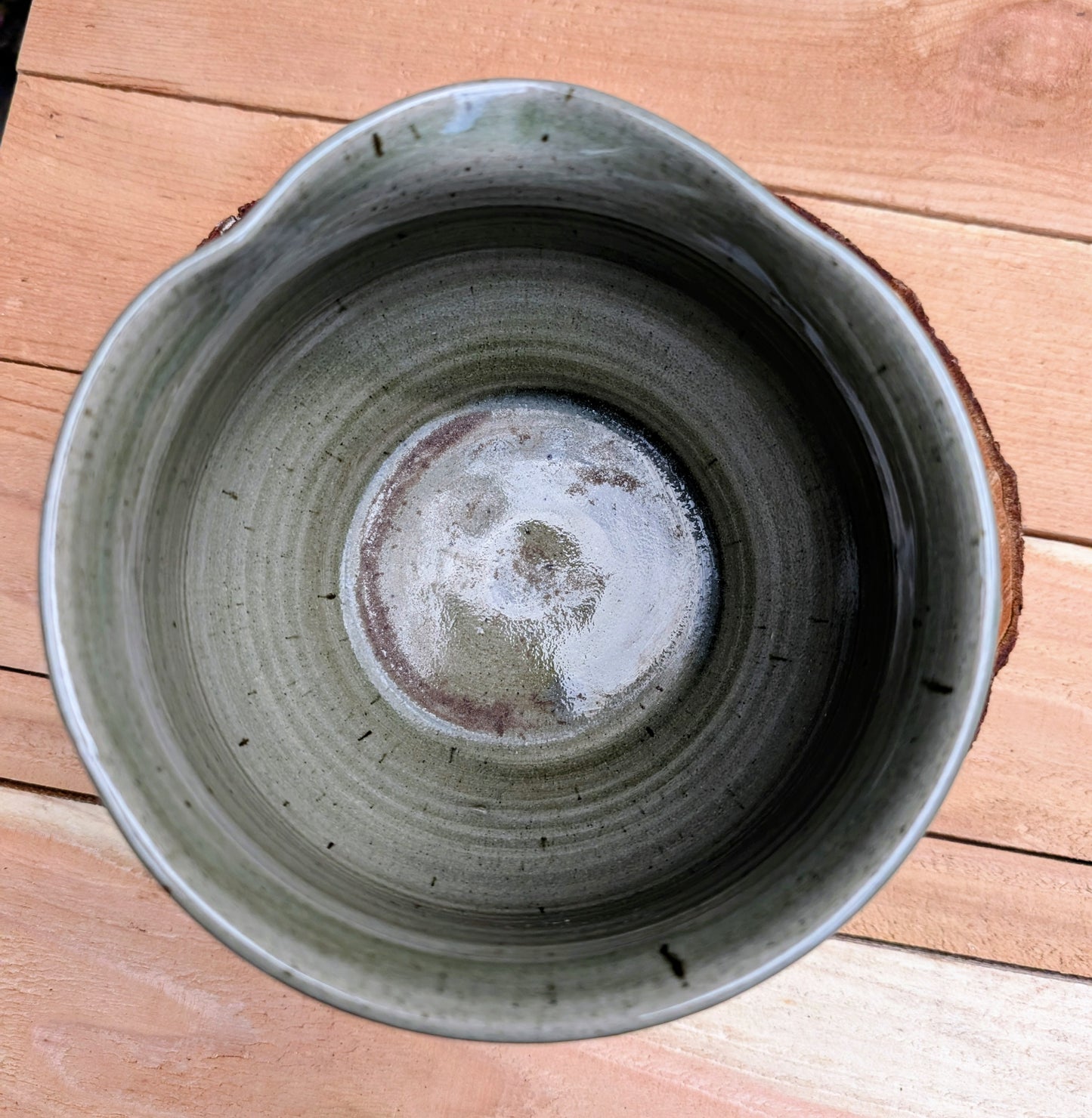 A beautifully hand-thrown studio pottery pouring bowl featuring a soft blue-green celadon glaze over warm buff stoneware. Equally suited for serving, light kitchen use, or display, this artisan-made piece celebrates the beauty of handcrafted ceramics and timeless functional design.