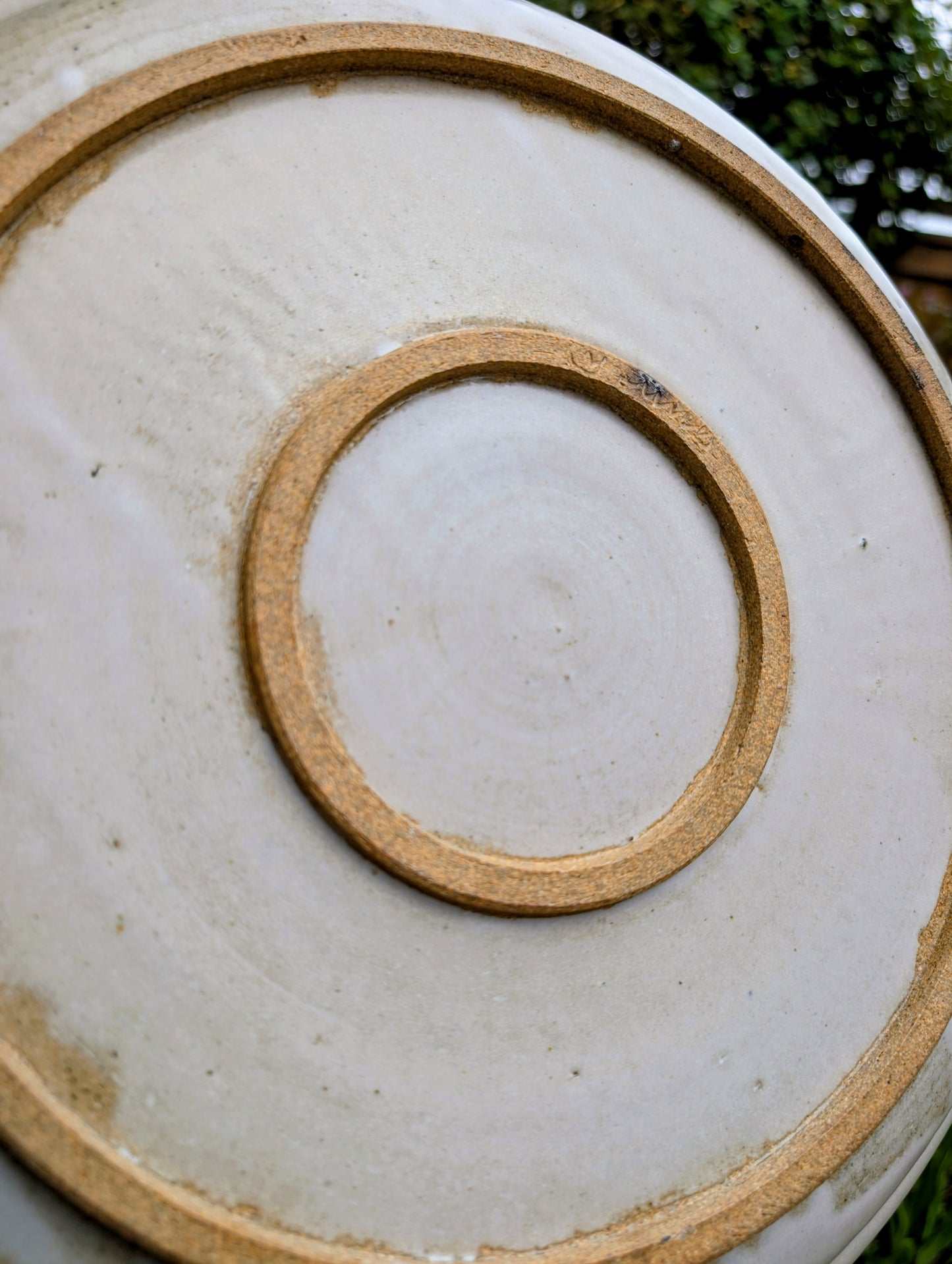 A beautifully hand-thrown studio pottery platter featuring expressive blue-gray and olive brushwork over a soft neutral glaze. Its generous size and timeless craftsmanship make it equally suited for serving, display, or as striking wall décor.