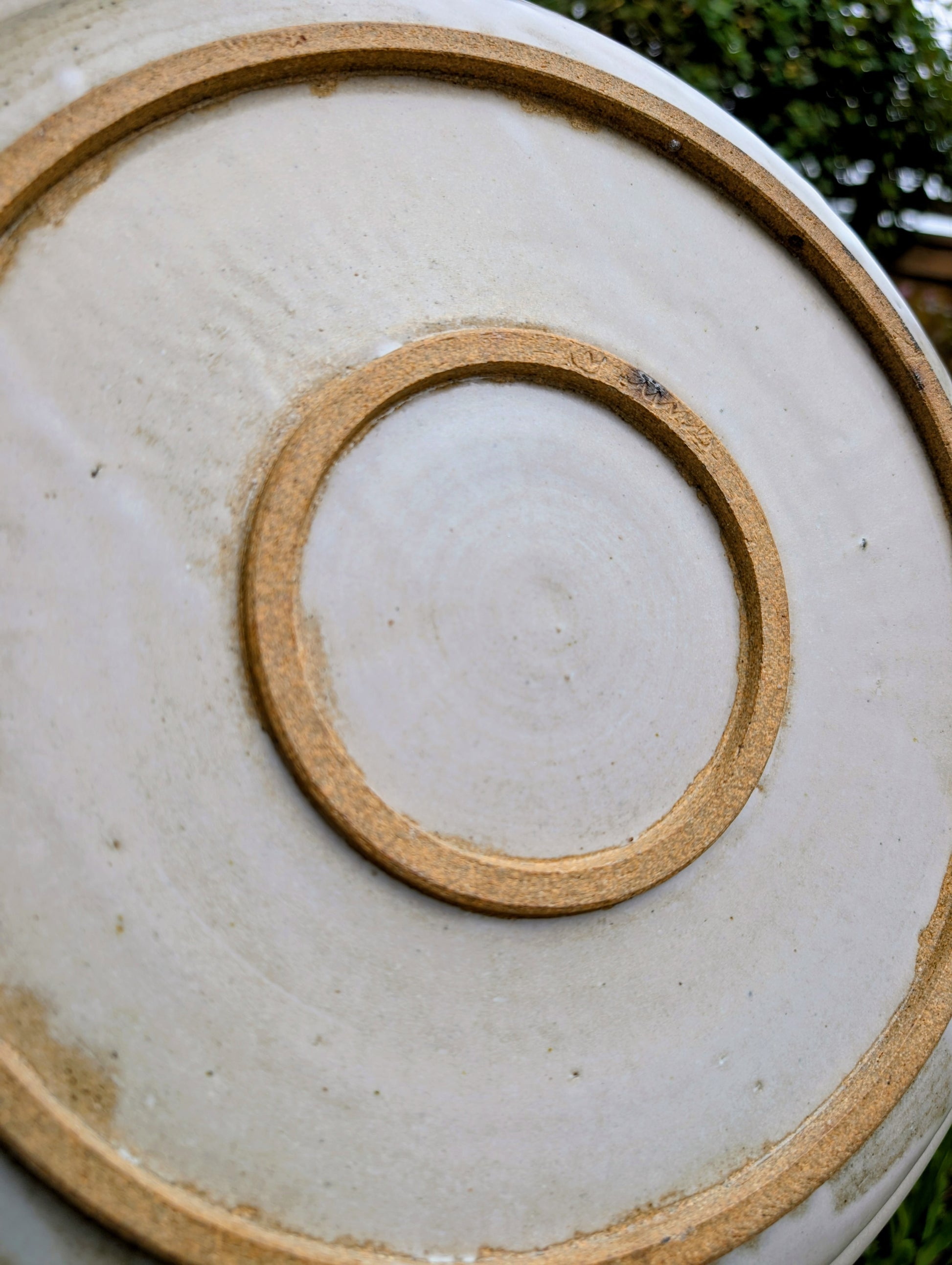A beautifully hand-thrown studio pottery platter featuring expressive blue-gray and olive brushwork over a soft neutral glaze. Its generous size and timeless craftsmanship make it equally suited for serving, display, or as striking wall décor.