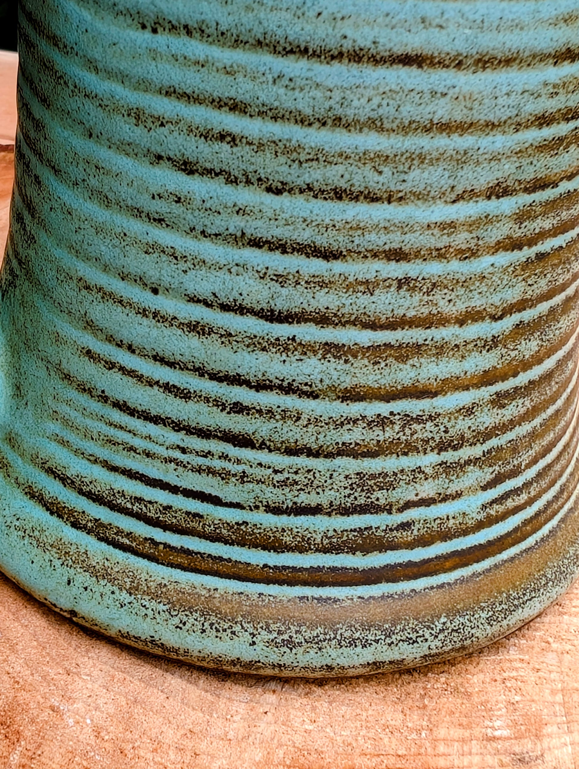 A beautifully handcrafted studio pottery tankard-style mug, wheel-thrown in Hot Springs, Arkansas and dated 2007. Its flowing turquoise, olive, and bronze glaze, generous size, and comfortable thumb-rest handle make it both a functional everyday piece and a collectible example of American studio pottery.