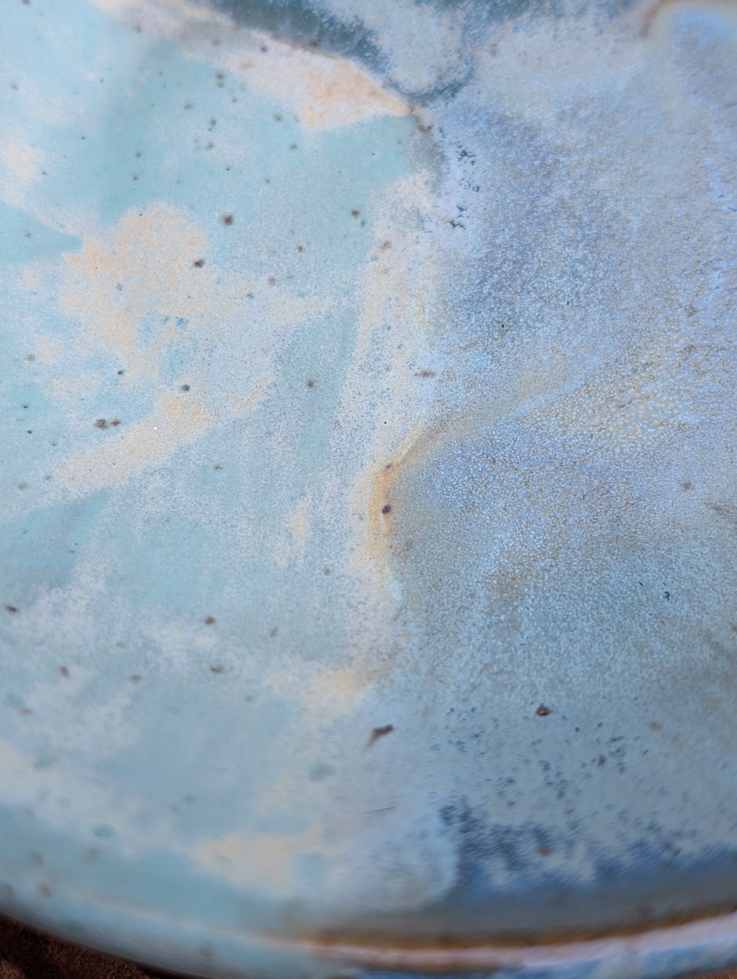 Bring the calming colors of the Pacific Northwest into your home with this handcrafted studio pottery bowl. Featuring layered blue, aqua, cream, and olive reactive glazes, this artisan stoneware piece is equally beautiful as a serving bowl or decorative display.