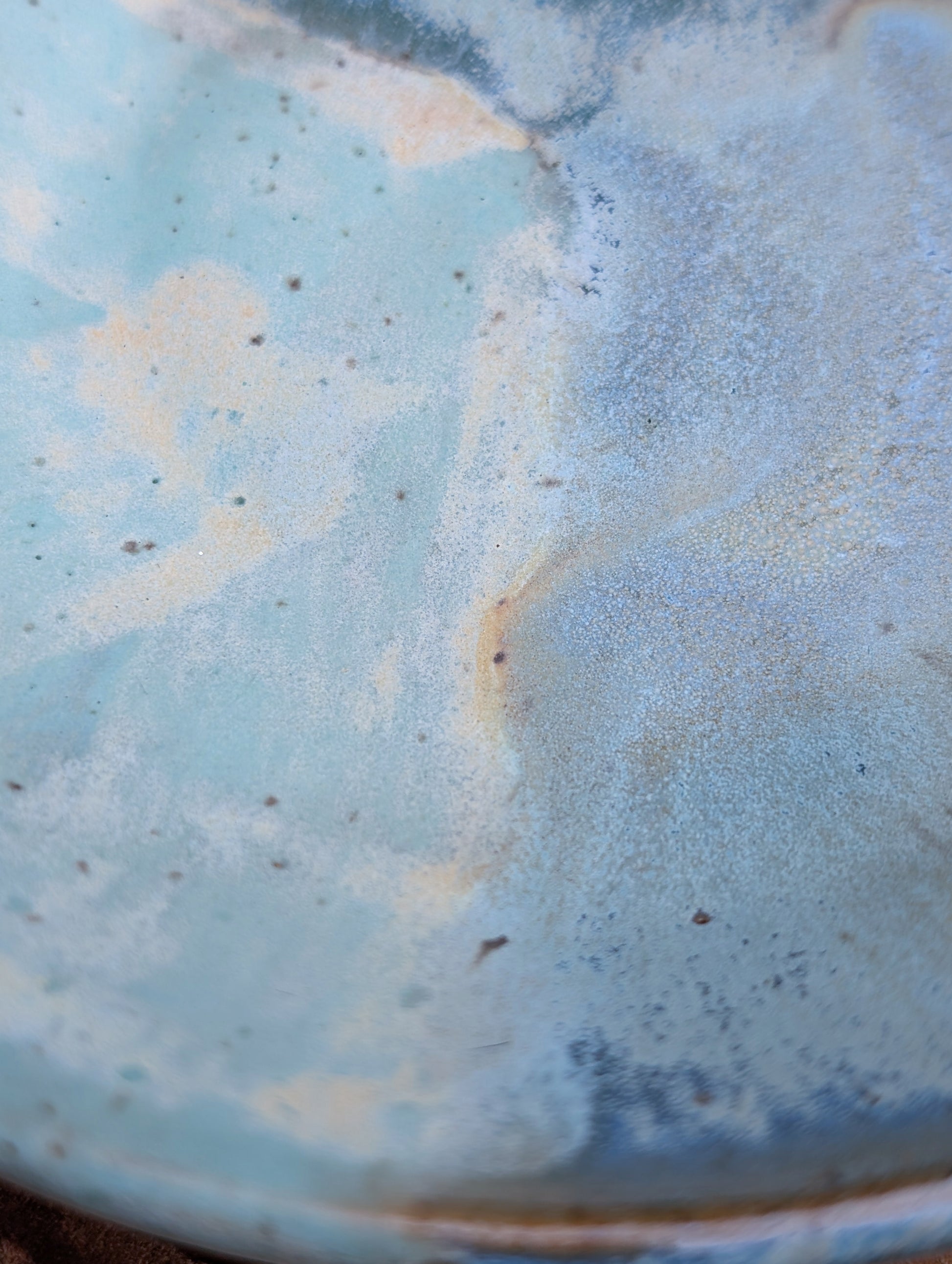 Bring the calming colors of the Pacific Northwest into your home with this handcrafted studio pottery bowl. Featuring layered blue, aqua, cream, and olive reactive glazes, this artisan stoneware piece is equally beautiful as a serving bowl or decorative display.