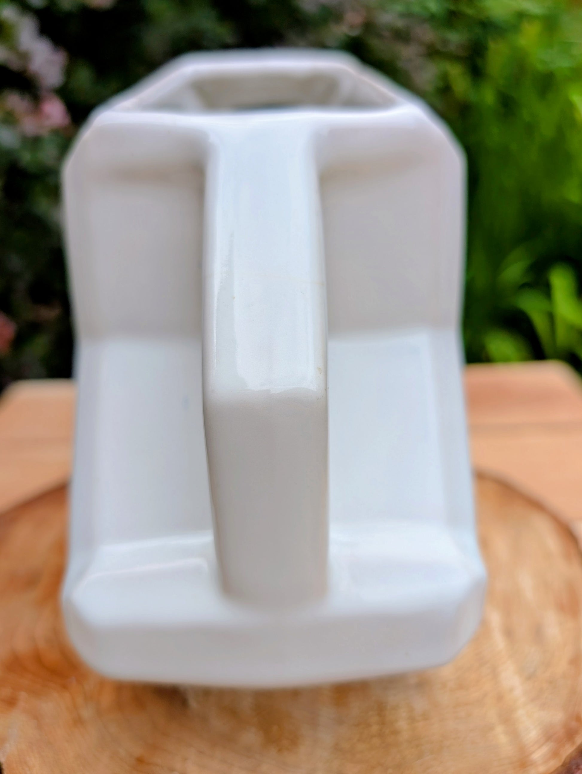 Bring timeless American Art Deco design into your home with this vintage Alamo Pottery Shape No. 758 pitcher. Its crisp geometric silhouette and glossy white glaze make it equally beautiful as a functional pitcher, sculptural vase, or decorative accent.