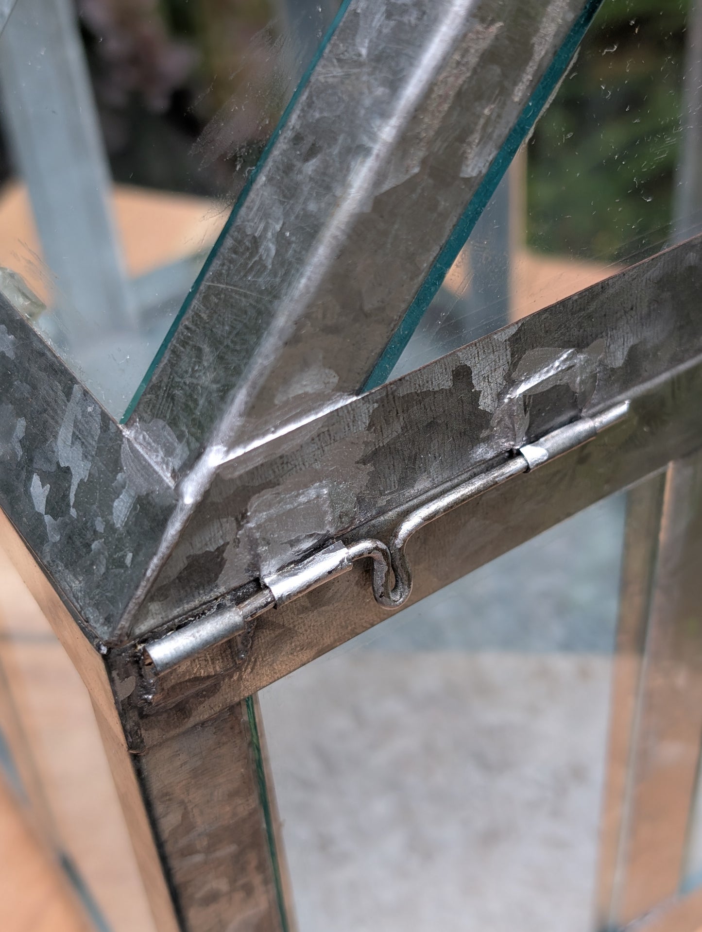 Bring the charm of a Victorian conservatory indoors with this decorative galvanized metal and glass tabletop greenhouse. Perfect for displaying succulents, moss gardens, candles, seasonal décor, or treasured collectibles, it adds timeless botanical style to any room.