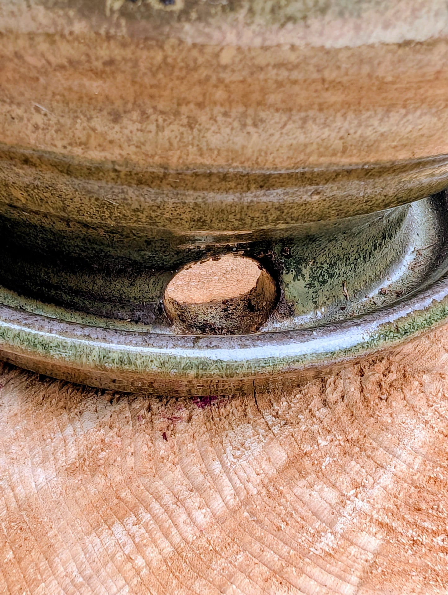 Handcrafted in Snohomish, Washington, this authentic Bruning Pottery stoneware planter showcases flowing moss green, olive, brown, and plum glazes inspired by the Pacific Northwest landscape. Complete with an integrated saucer, it's a beautiful and functional piece for houseplants, herbs, or succulent collections.