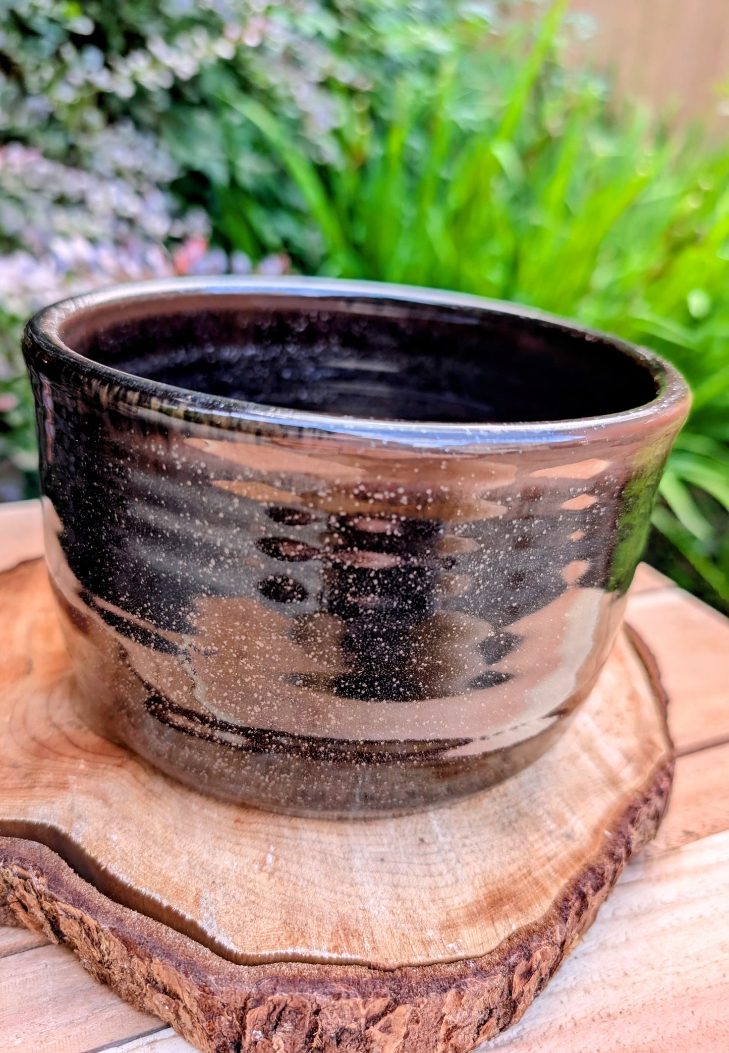 Bring the warmth of Pacific Northwest craftsmanship to your home with this authentic Bruning Pottery stoneware bowl from the studio's Seattle era. Featuring a rich iron-speckled glaze and wheel-thrown construction, it's equally beautiful as a serving bowl, planter cachepot, or decorative display piece.