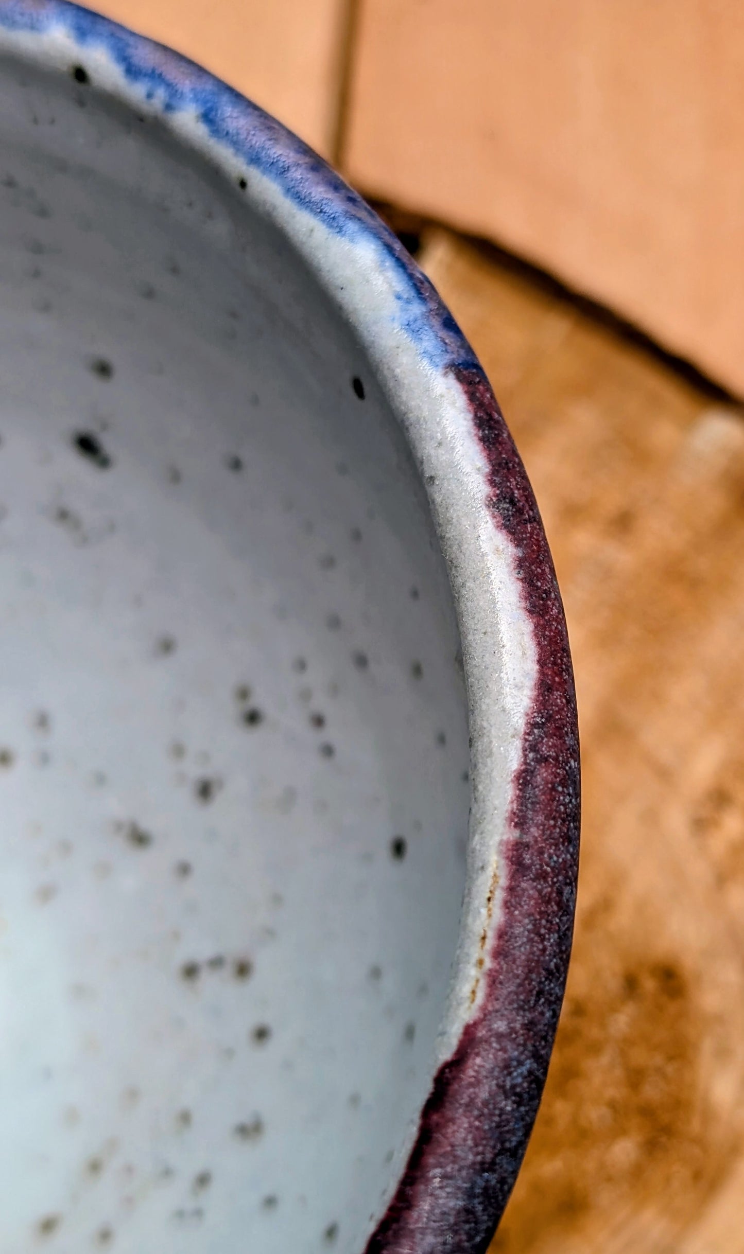 Bring handcrafted artistry to your home with this small footed studio pottery bowl featuring layered reactive glazes in purple, blue, charcoal, and earthy brown. Wheel-thrown from high-fired stoneware, its one-of-a-kind finish makes it equally beautiful as functional tableware or decorative art.