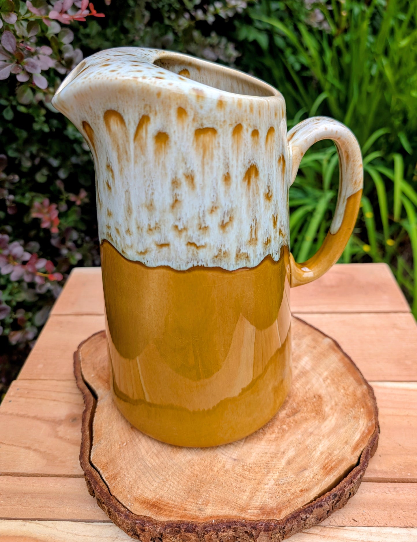 Bring timeless American craftsmanship into your home with this vintage Canonsburg Pottery Carefree Ironstone pitcher in the sought-after Butterscotch pattern. Its warm caramel glaze and signature white drip finish make it equally beautiful as a serving pitcher, floral vase, or rustic farmhouse accent.