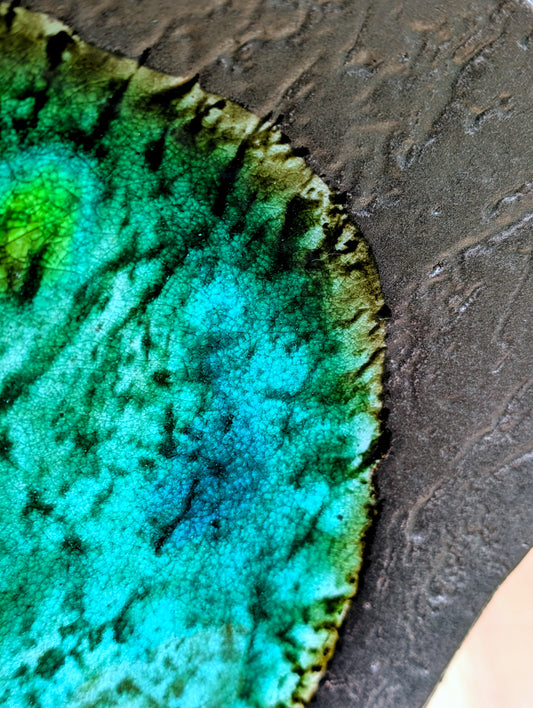 Bring the quiet beauty of Japanese ceramic artistry into your home with this vintage Yūsansai-inspired stoneware plate. Its flowing emerald, turquoise, and olive crystalline glazes make every piece uniquely expressive, perfect as a decorative centerpiece or sculptural accent.