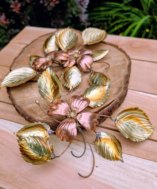 Bring the warmth of 1970s botanical décor into your home with this charming pair of vintage brass and copper-tone dogwood wall sculptures. Their delicate floral design and mixed-metal finish make them an easy addition to Mid-Century Modern, cottage, and nature-inspired interiors.