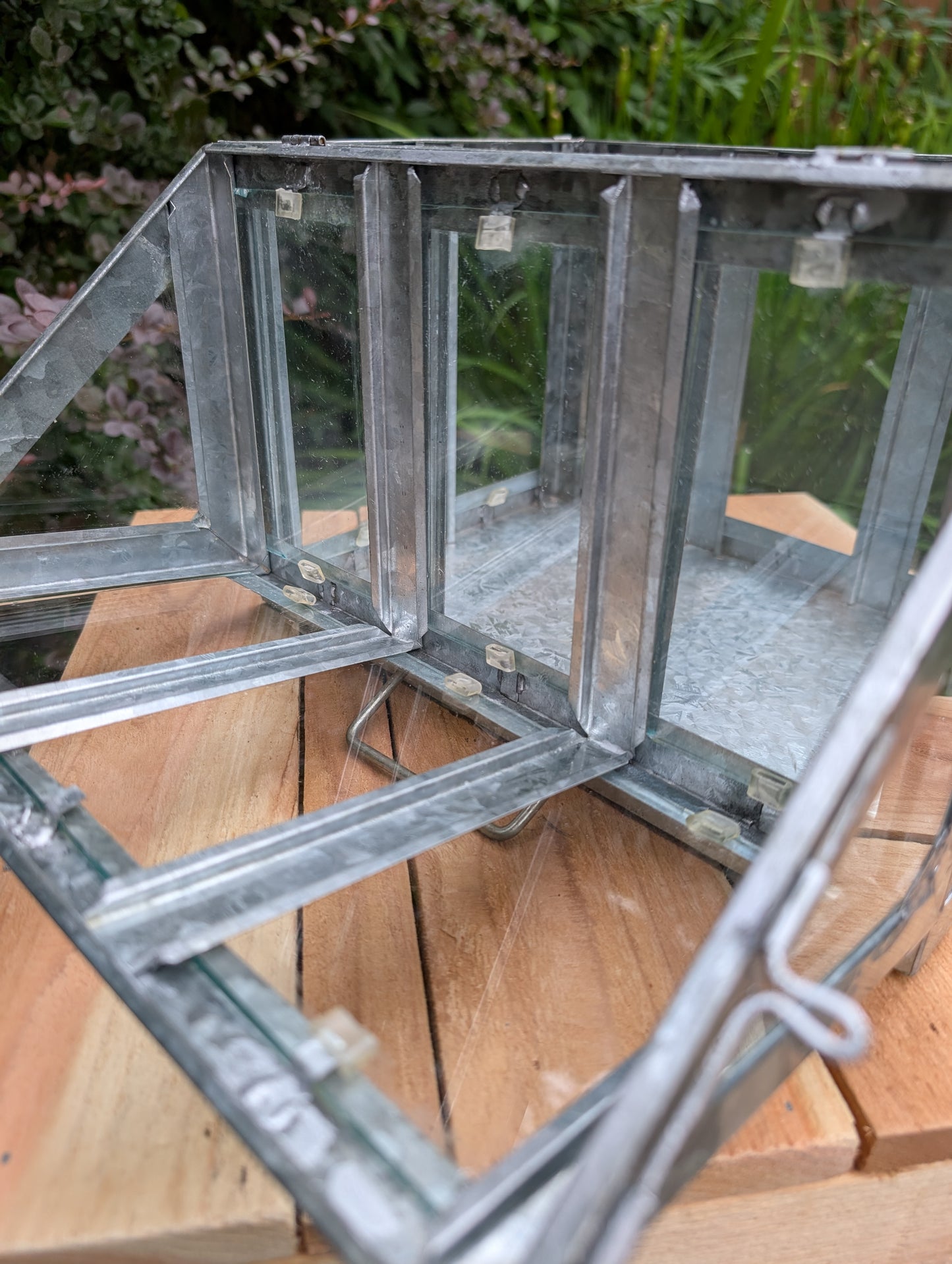 Bring the charm of a Victorian conservatory indoors with this decorative galvanized metal and glass tabletop greenhouse. Perfect for displaying succulents, moss gardens, candles, seasonal décor, or treasured collectibles, it adds timeless botanical style to any room.