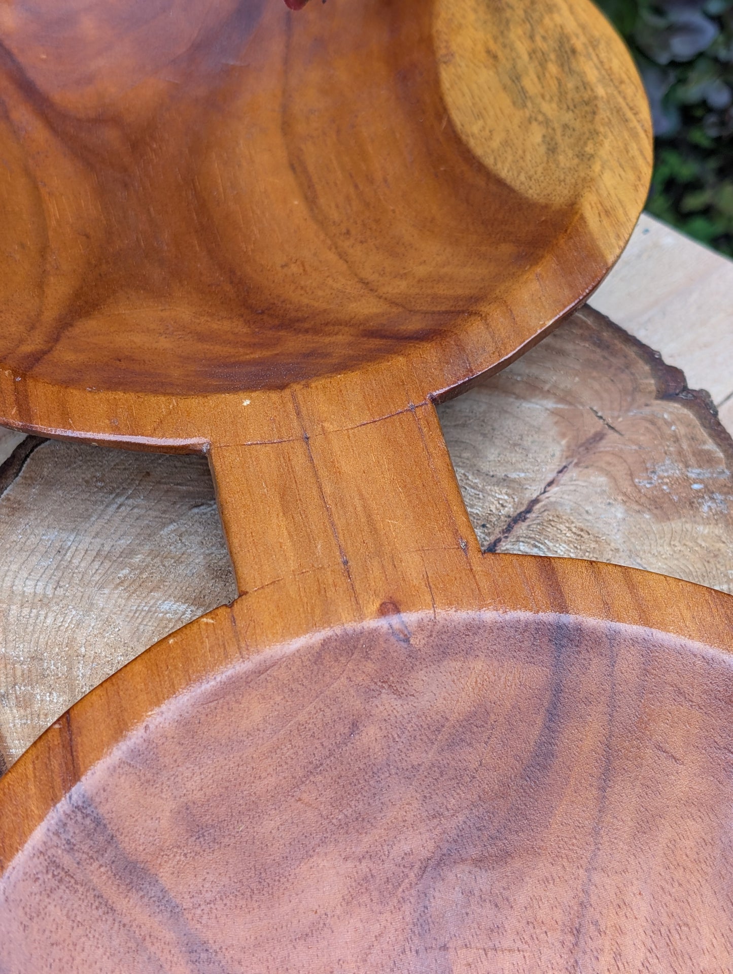Serve with timeless style using this hand-carved Monkey Pod wood double serving tray. Crafted from a single piece of richly grained hardwood, its sculptural silhouette makes it equally beautiful as a serving piece or decorative centerpiece.