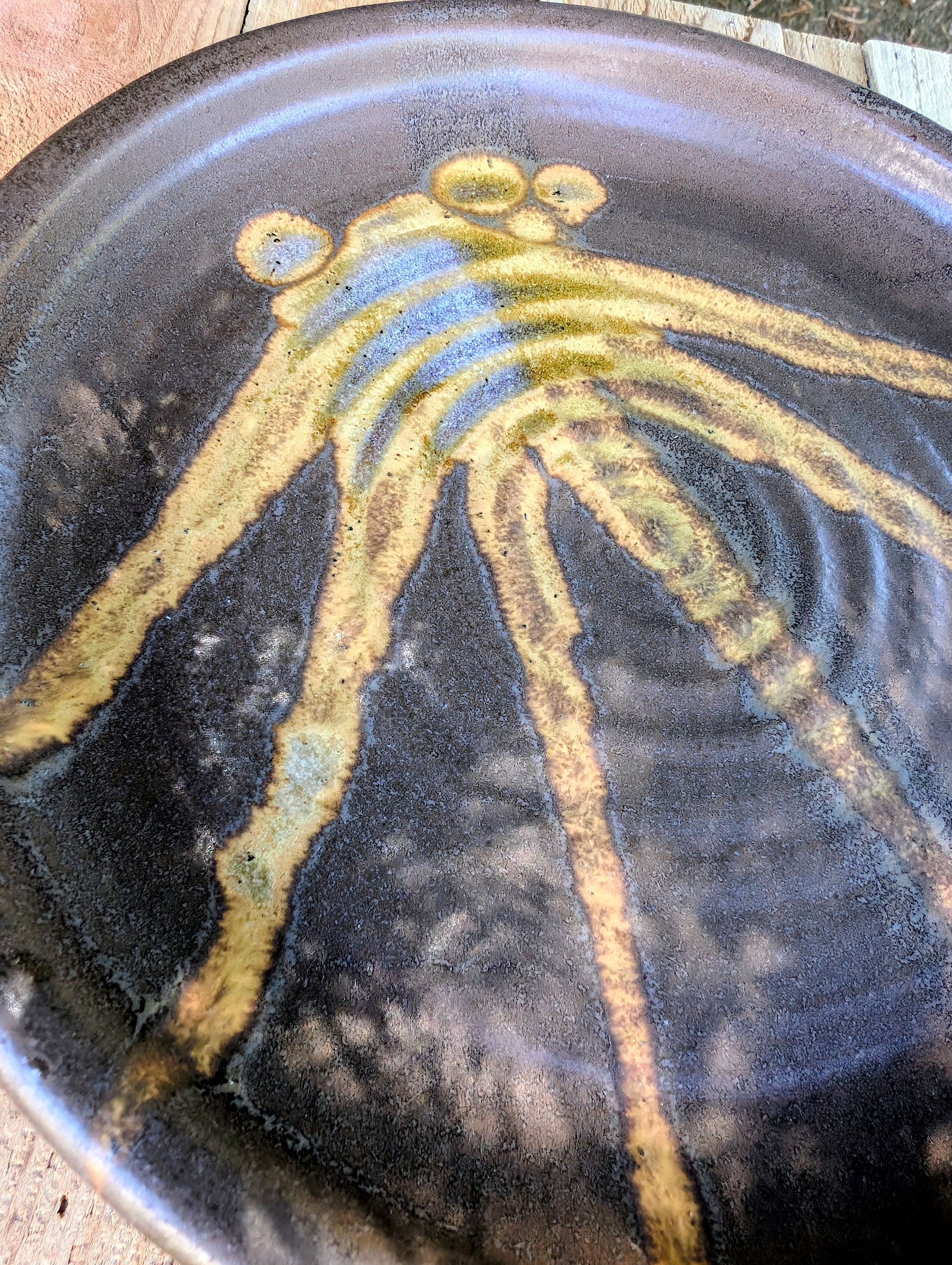 Celebrate the beauty of handmade craftsmanship with this one-of-a-kind studio pottery art plate featuring an expressive abstract octopus-inspired design. Rich earth-tone glazes and visible throwing rings make this versatile stoneware piece equally at home as functional serveware or coastal-inspired wall décor.