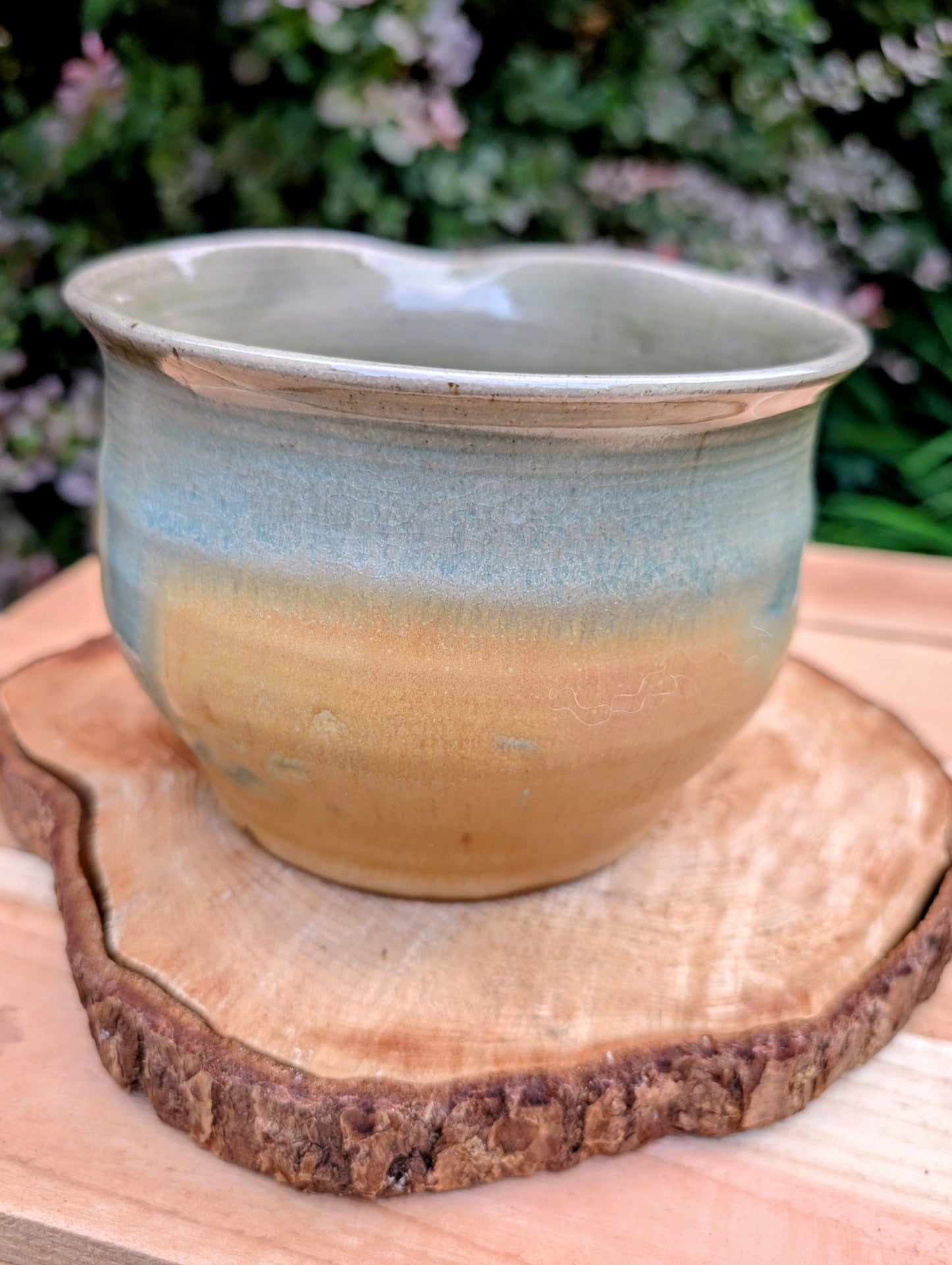 A beautifully hand-thrown studio pottery pouring bowl featuring a soft blue-green celadon glaze over warm buff stoneware. Equally suited for serving, light kitchen use, or display, this artisan-made piece celebrates the beauty of handcrafted ceramics and timeless functional design.