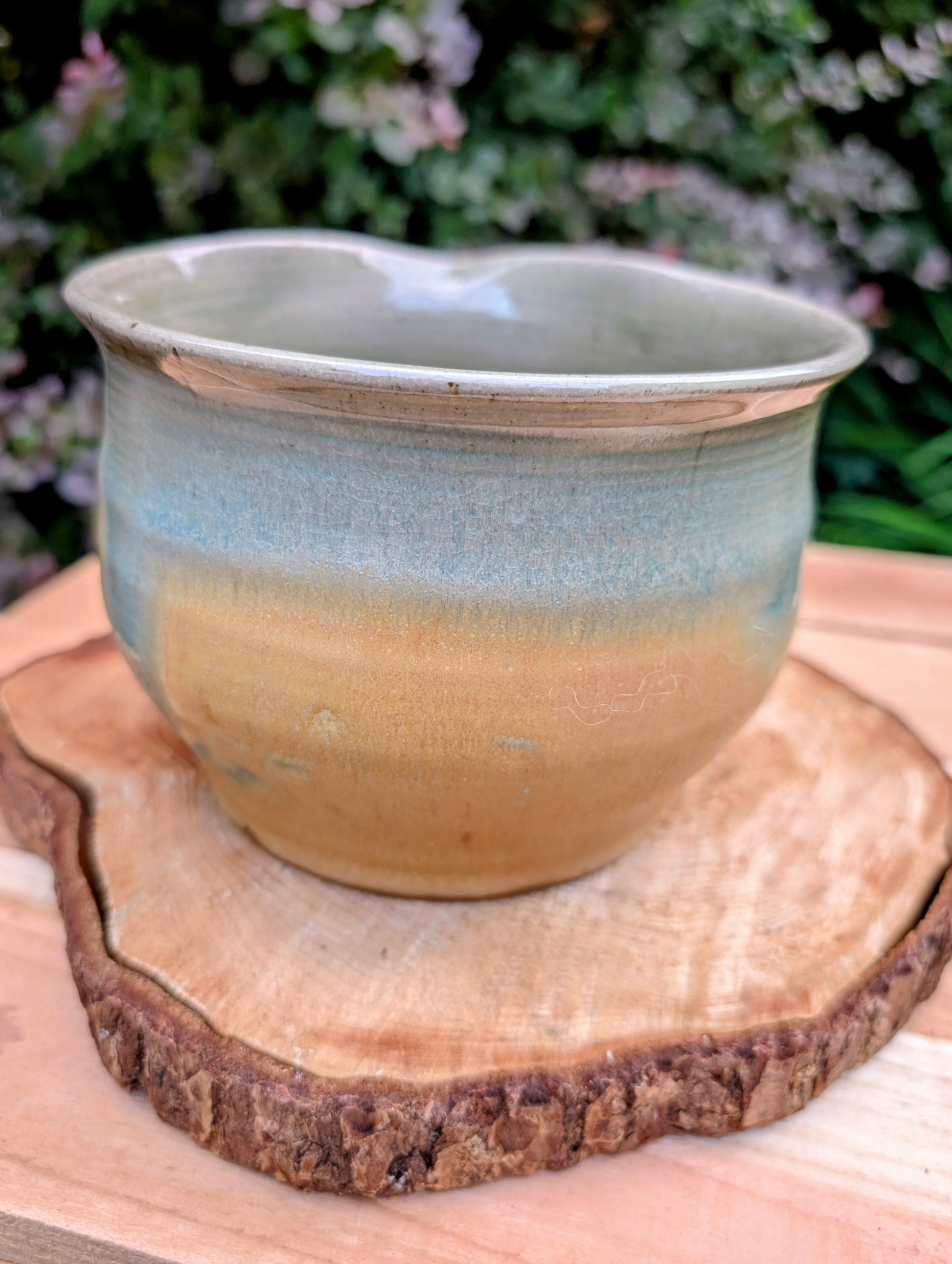 A beautifully hand-thrown studio pottery pouring bowl featuring a soft blue-green celadon glaze over warm buff stoneware. Equally suited for serving, light kitchen use, or display, this artisan-made piece celebrates the beauty of handcrafted ceramics and timeless functional design.