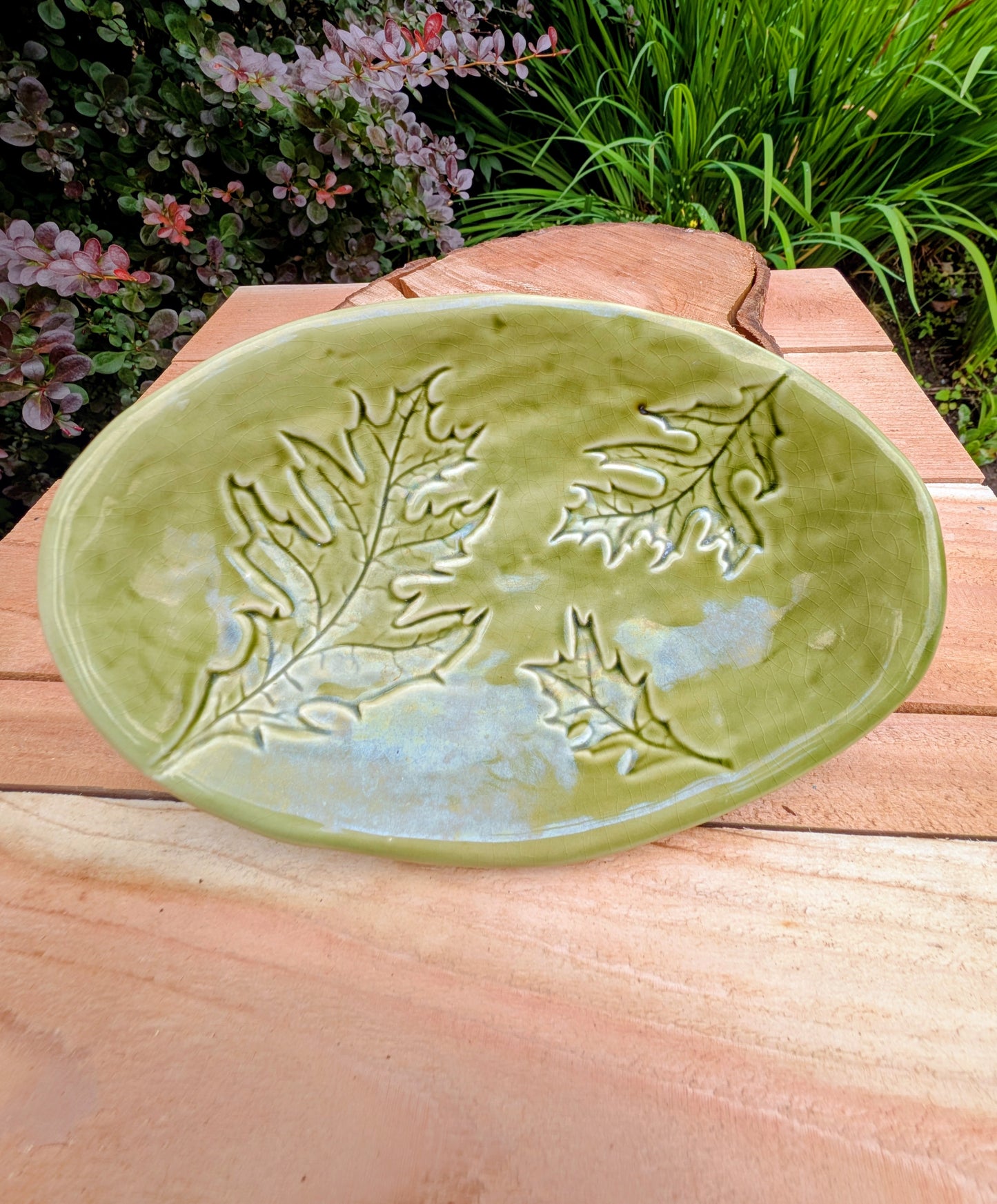 Celebrate the beauty of the forest with this handcrafted embossed oak leaf ceramic dish. Featuring a rich olive-green glaze and an organic form, it's equally at home serving small bites, holding jewelry, or adding a touch of Pacific Northwest charm to your décor.
