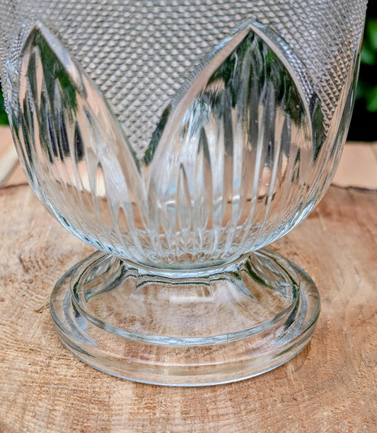 Bring timeless vintage charm to your home with this elegant clear pressed glass covered candy dish featuring a classic diamond-point pattern and pedestal base. Perfect for displaying wrapped candies, jewelry, potpourri, or treasured keepsakes, this versatile piece adds sparkle to any room.