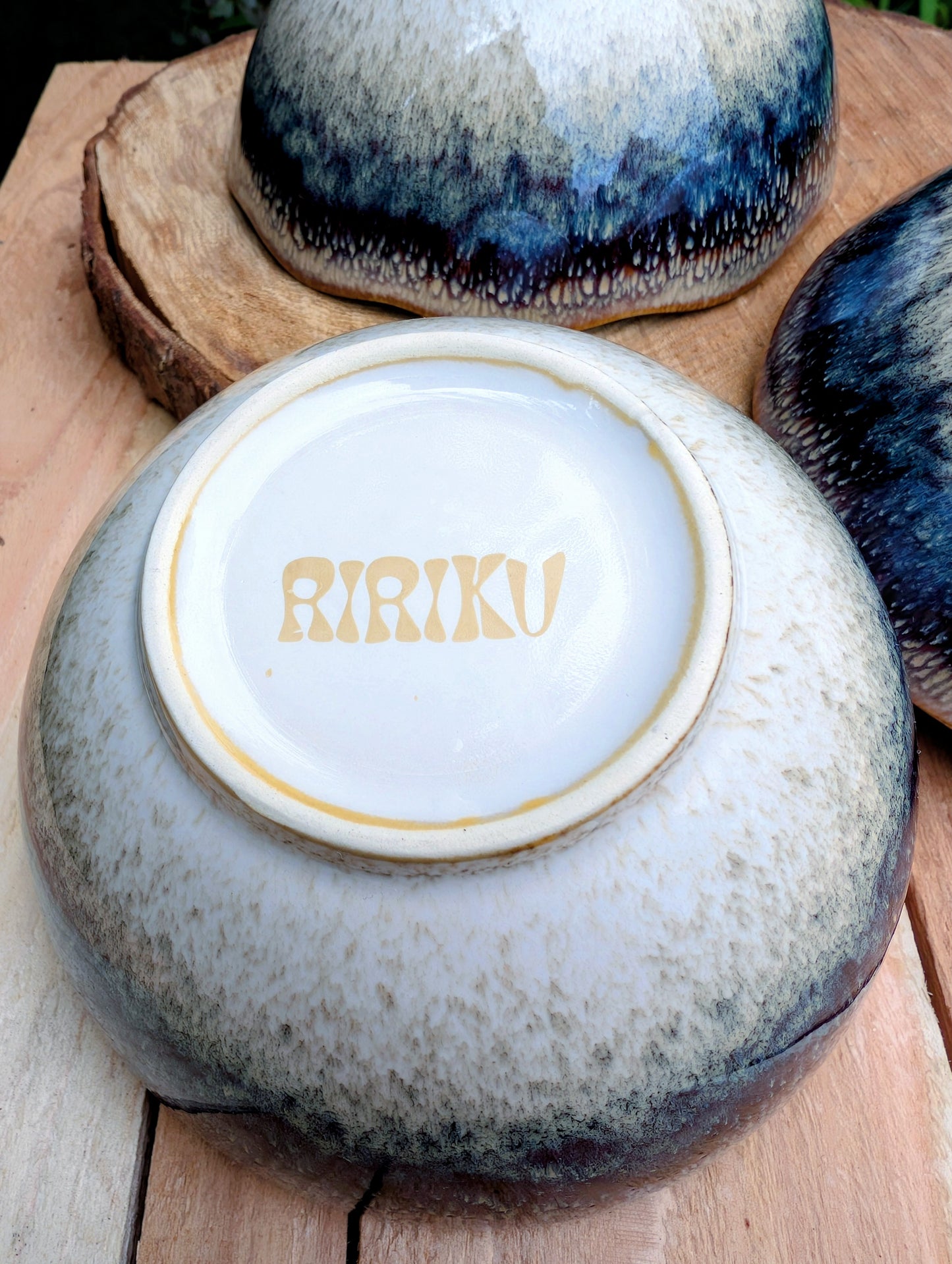 Bring understated elegance to everyday dining with this set of three RIRAKU stackable stoneware bowls. Featuring organically scalloped rims and beautifully layered reactive glazes inspired by traditional Japanese pottery, these versatile bowls are perfect for soups, rice, snacks, desserts, and small shared dishes.