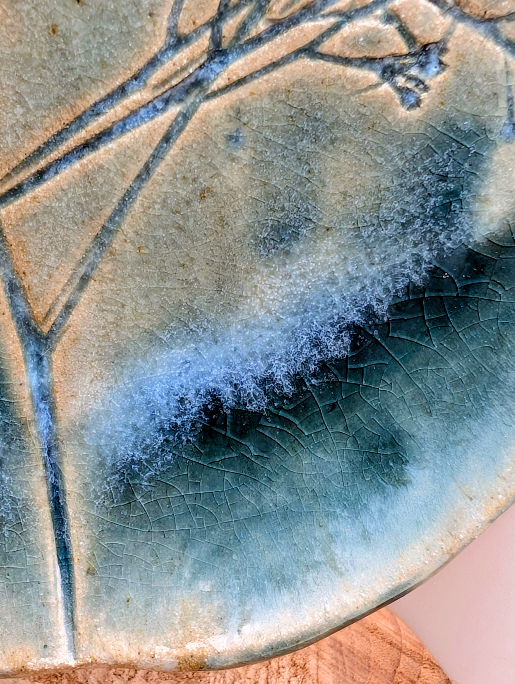 Celebrate the beauty of nature with this signed handbuilt studio pottery platter featuring an elegant botanical relief impressed directly into the clay. Finished in layered blue, teal, and olive glazes, this contemporary stoneware piece is equally at home as functional serveware or displayed as ceramic wall art.
