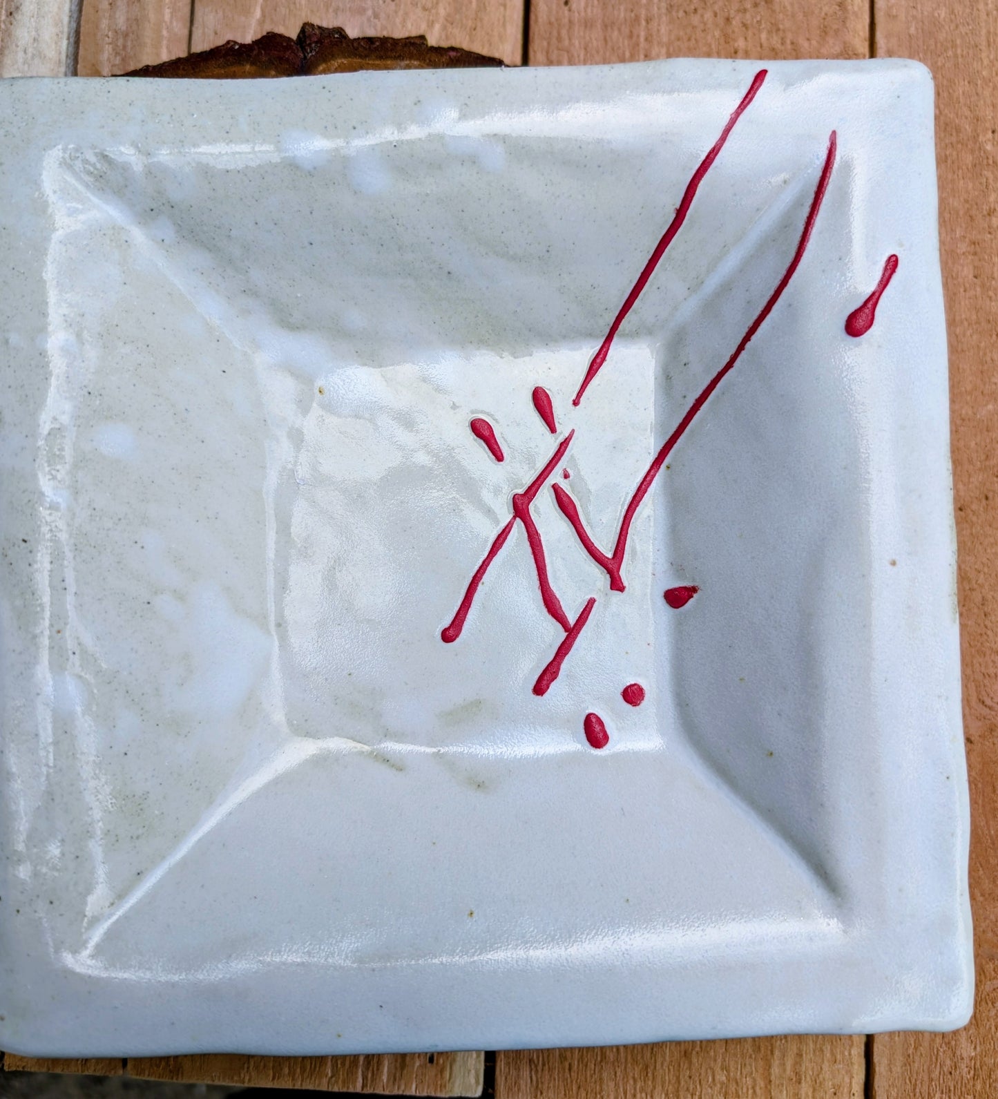 Bring handcrafted artistry into your home with this unsigned studio pottery catchall dish featuring a sculptural folded-corner design and expressive red slip decoration. Beautiful as both functional pottery and contemporary décor, it offers timeless Pacific Northwest style with organic modern appeal.