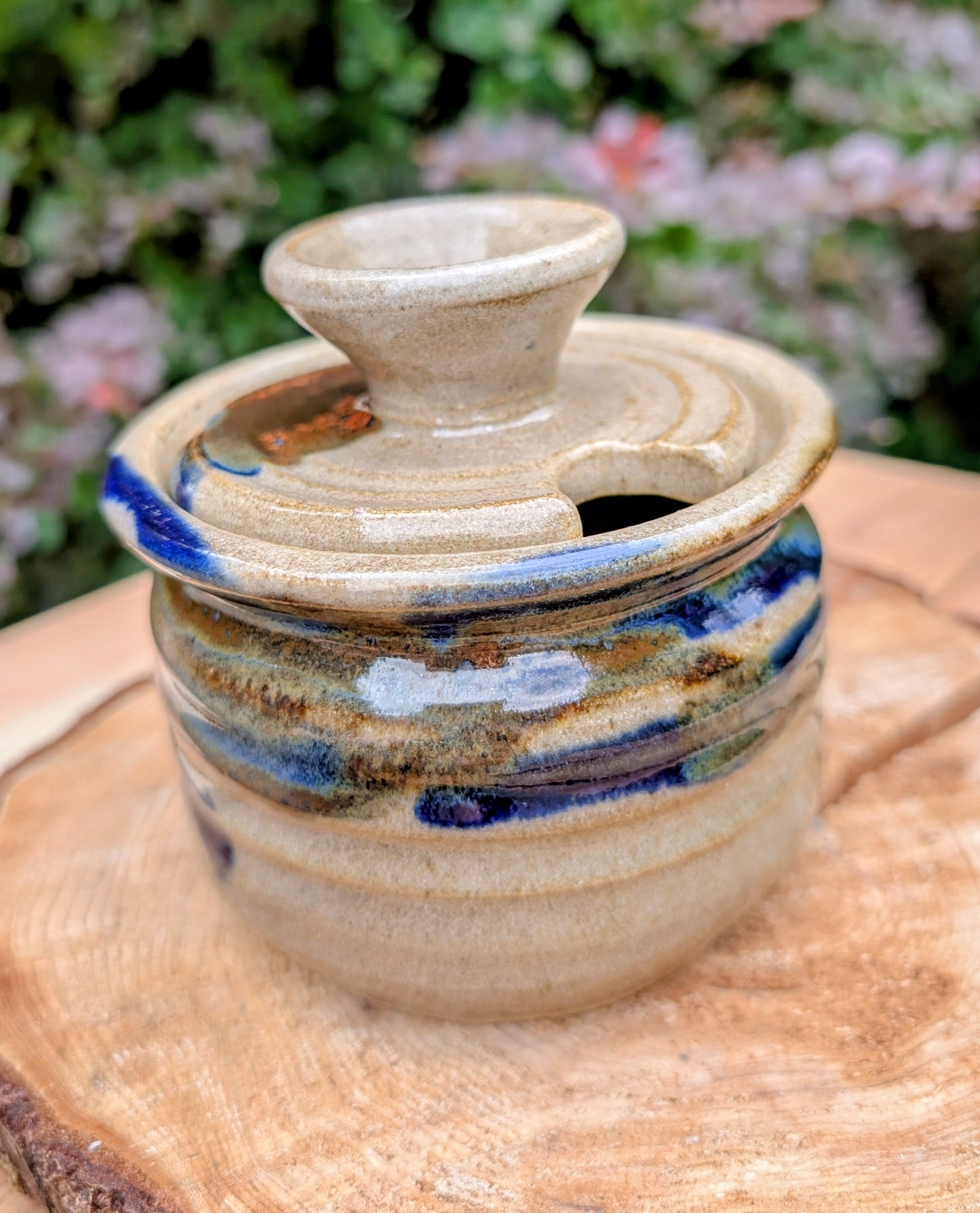 Bring handcrafted warmth to your kitchen with this signed studio pottery lidded jam pot featuring richly layered cobalt blue, olive, brown, and tan glazes. Perfect for serving honey, preserves, sugar, or favorite condiments, this artisan stoneware piece is both beautiful and functional.