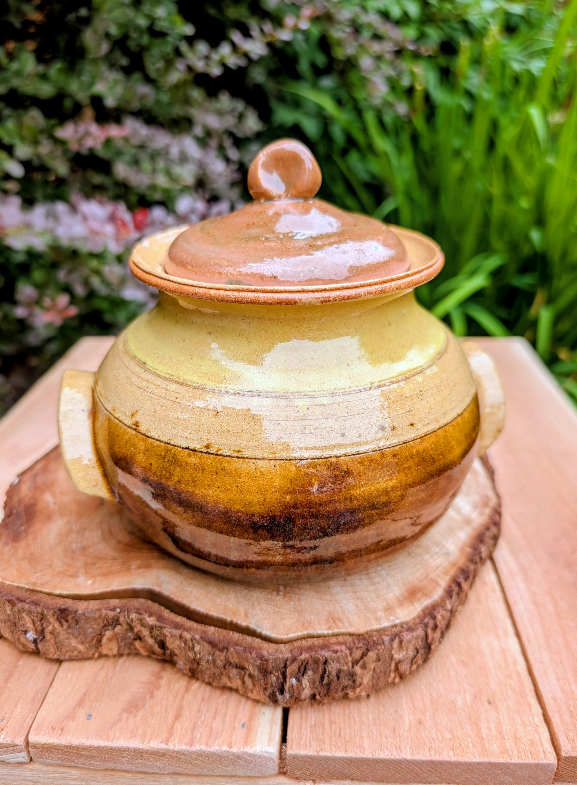 Bring timeless craftsmanship to your kitchen with this handcrafted studio pottery lidded stoneware pot. Finished in warm honey, caramel, olive, and tan glazes, this versatile covered vessel is equally beautiful as functional serveware or rustic farmhouse décor.