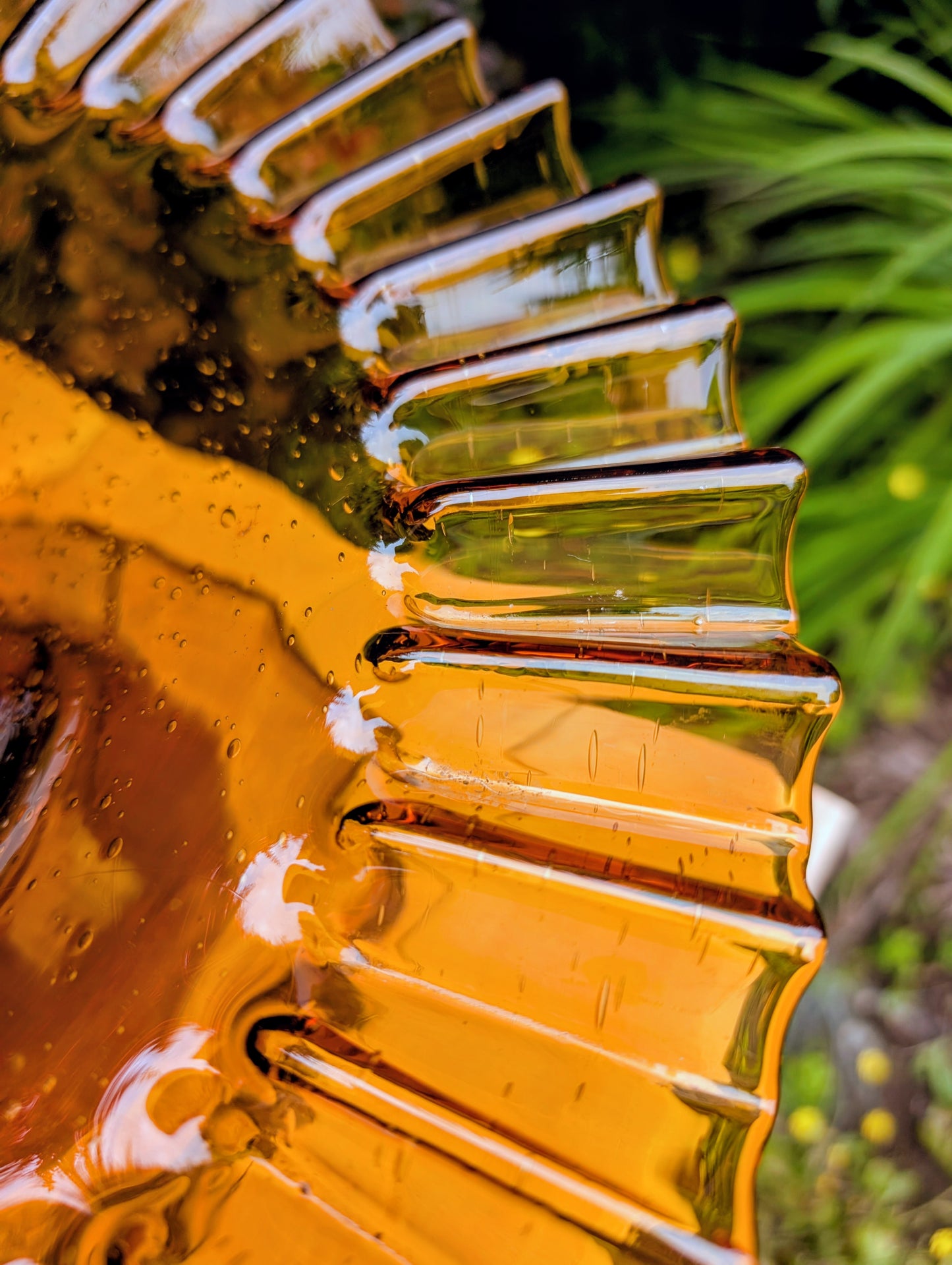 Bring warm vintage charm to your home with this large amber pressed glass pedestal console bowl, estimated to have been made by Indiana Glass during the 1960s–1970s. Its dramatic ruffled rim and generous size make it a beautiful centerpiece for seasonal displays, fruit, florals, or decorative accents throughout the year.