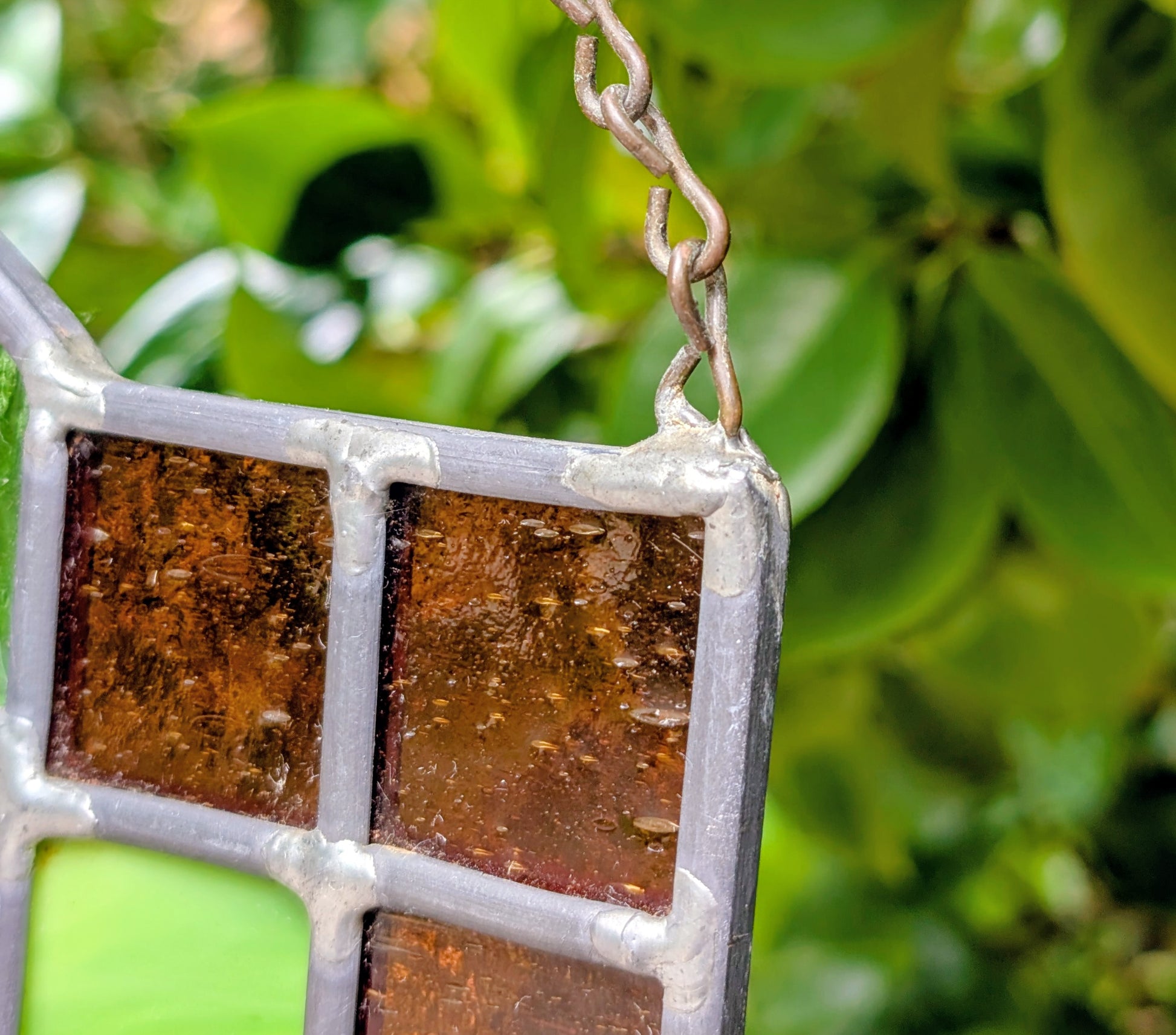 Bring the beauty of a hummingbird in bloom into your home with this handcrafted stained glass hanging panel. Featuring vibrant textured art glass surrounding a detailed hummingbird and hibiscus centerpiece, it catches natural light beautifully and adds year-round color to any window, sunroom, or garden-inspired space.