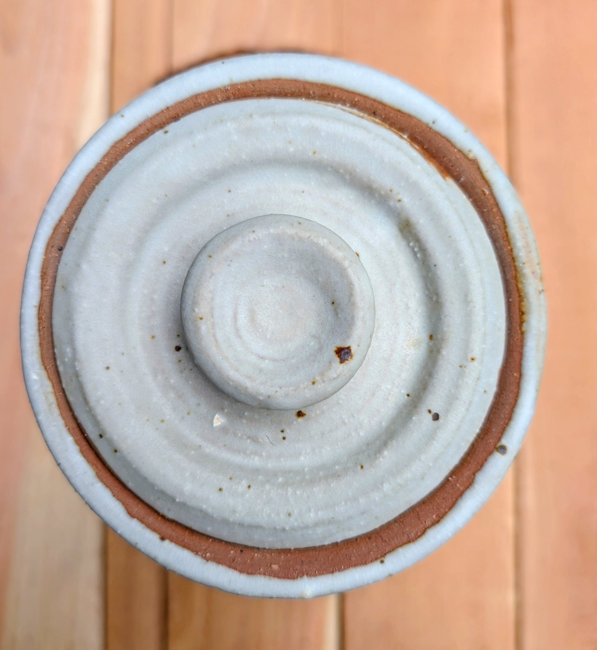 Bring warmth and handcrafted character to your kitchen with this wheel-thrown stoneware canister. Finished in a soft creamy-white glaze with subtle iron speckling, this timeless storage vessel blends rustic craftsmanship with modern organic design.