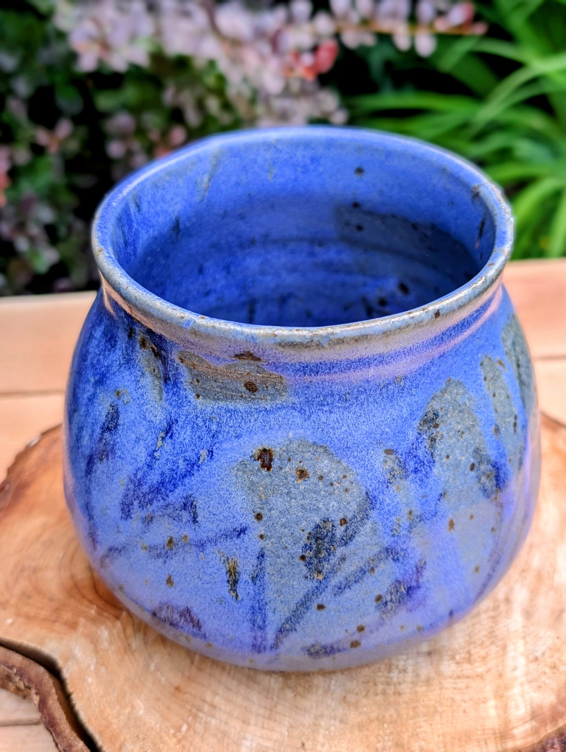 Handcrafted and artist-signed, this wheel-thrown stoneware vessel features a rich satin matte cobalt blue glaze accented with natural iron speckling. Originally created as a lidded storage jar, it now serves beautifully as a versatile open vessel for display or everyday use.
