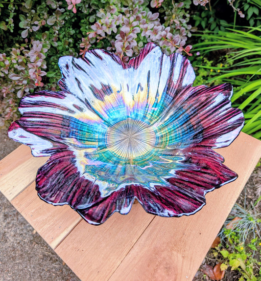 Bring color and artistry to your home or garden with this iridescent art glass floral bowl. Featuring shimmering purple and blue hues, it serves beautifully as either a striking tabletop centerpiece or a decorative bird bath bowl.