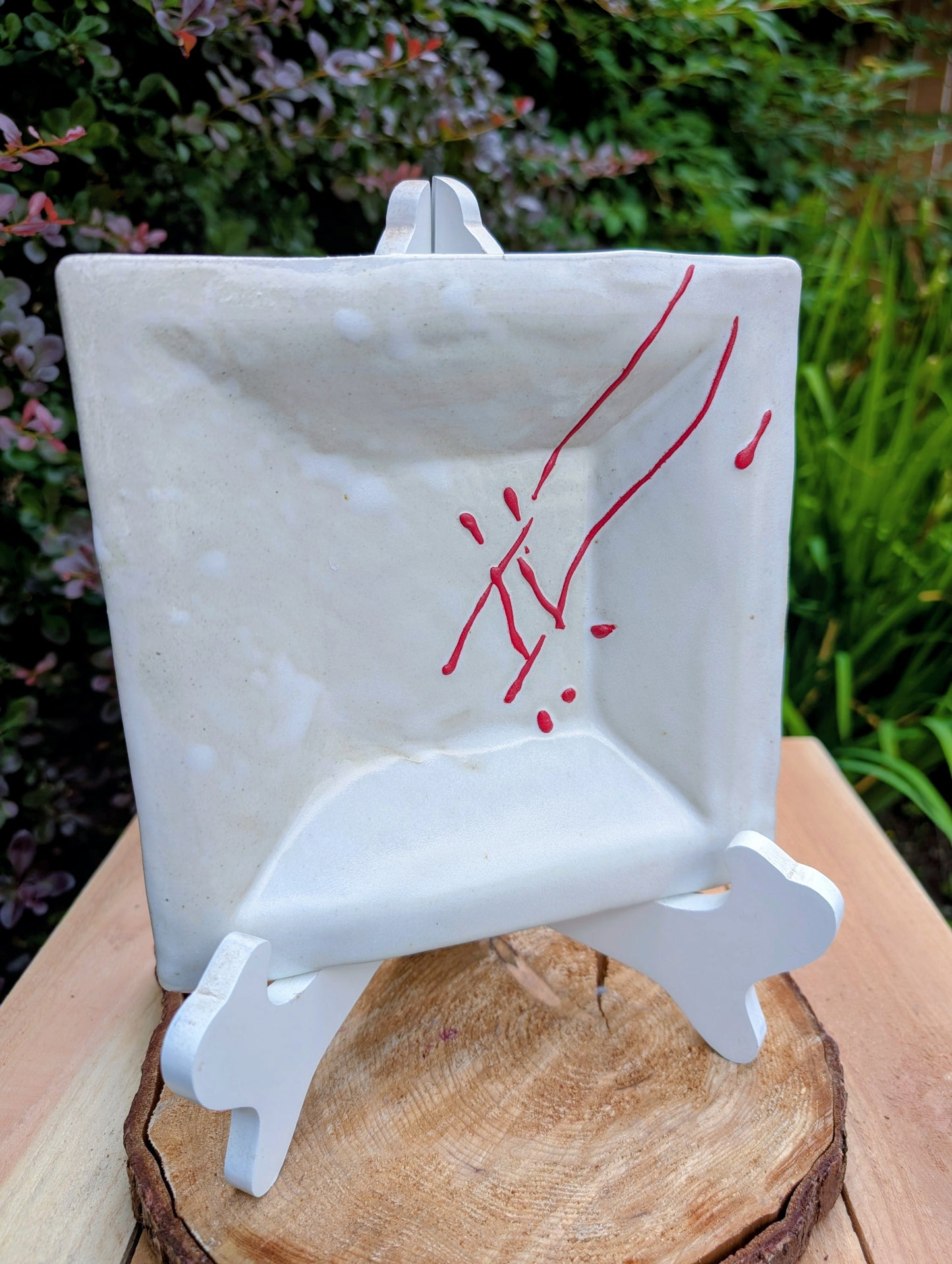 Bring handcrafted artistry into your home with this unsigned studio pottery catchall dish featuring a sculptural folded-corner design and expressive red slip decoration. Beautiful as both functional pottery and contemporary décor, it offers timeless Pacific Northwest style with organic modern appeal.
